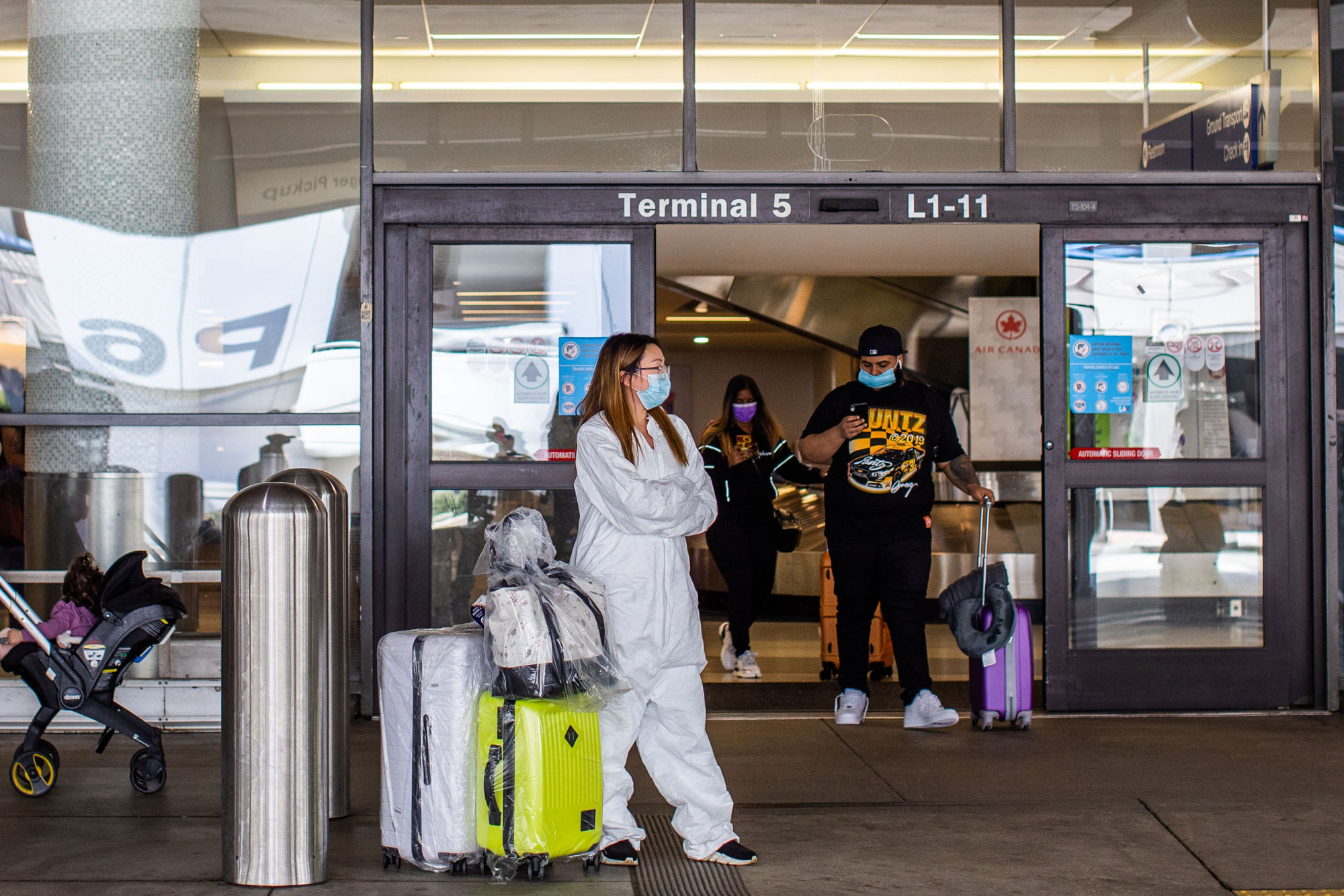 A woman waits for a ride at LAX Airport at the start of the Memorial Day holiday weekend in Los Angeles on May 22.