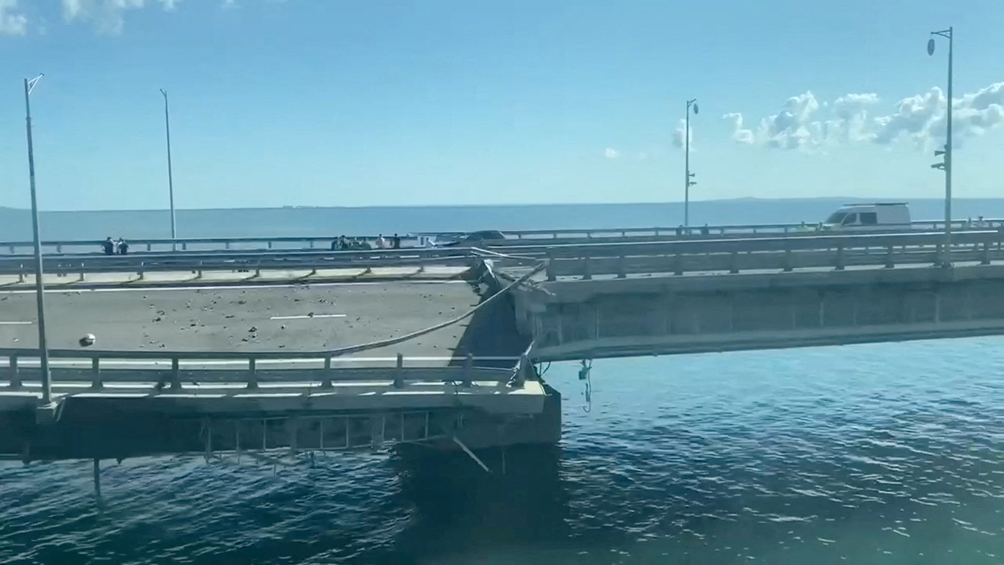 A view shows the section of a road split and sloping to one side following an alleged attack on the Crimea Bridge, that connects the Russian mainland with the Crimean peninsula across the Kerch Strait, in this still image taken from video released on July 17, 2023.