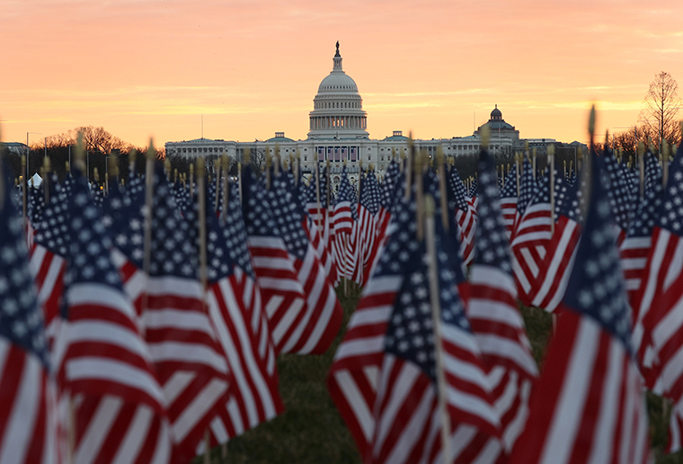 The U.S Capitol Building is prepared for the inaugural ceremonies for President-elect Joe Biden as American flags are placed in the ground on the National Mall on January 18, 2021 in Washington, DC. 