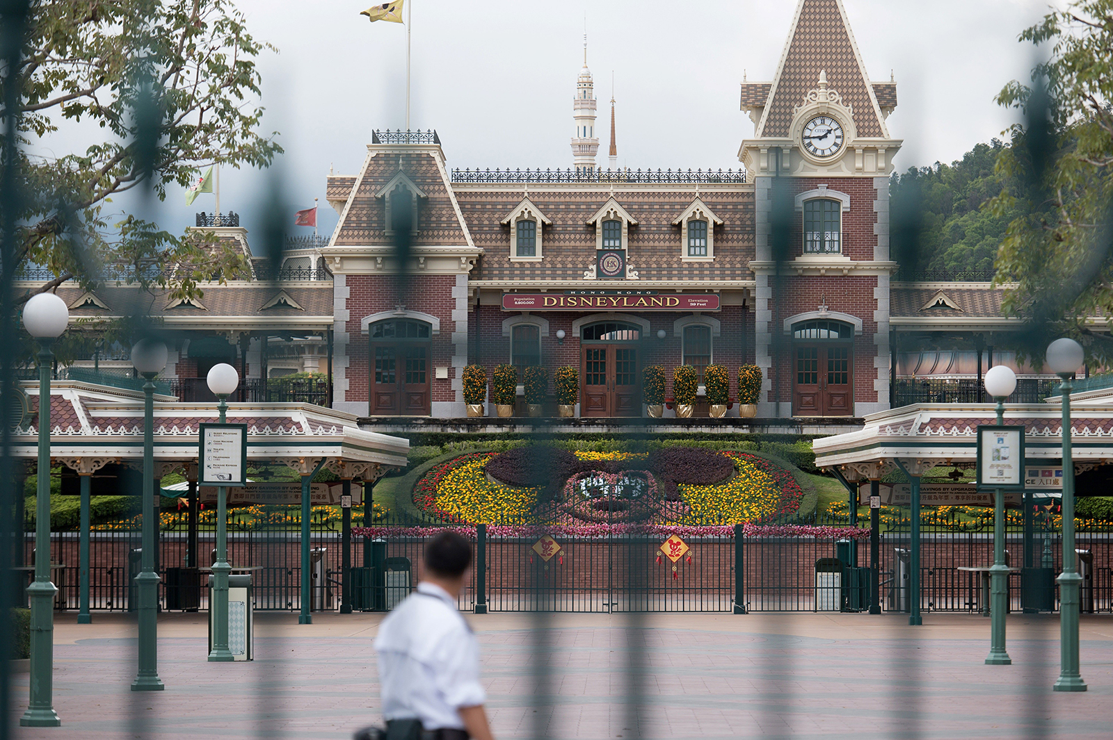 A security guard checks an empty square usually filled with visitors at Hong Kong Disneyland in Hong Kong on January 26.