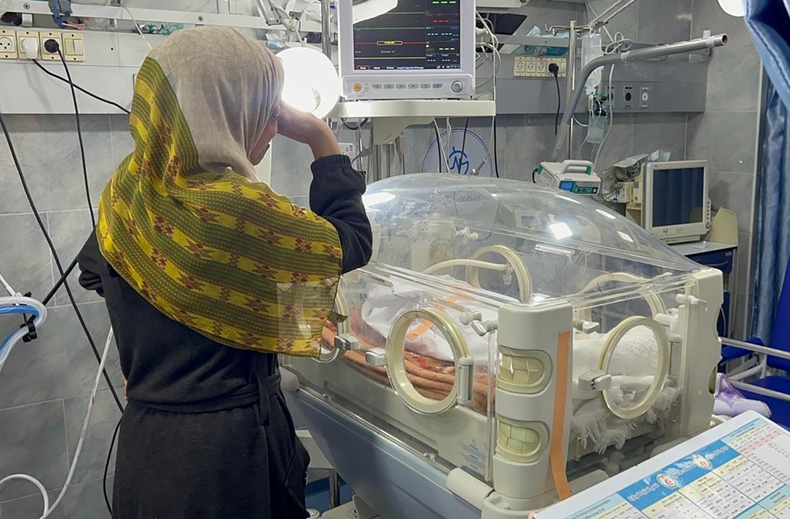 A mother mourns the death of her infant beside an incubator at Kamal Adwan Hospital in Beit Lahia, Gaza, on February 29.