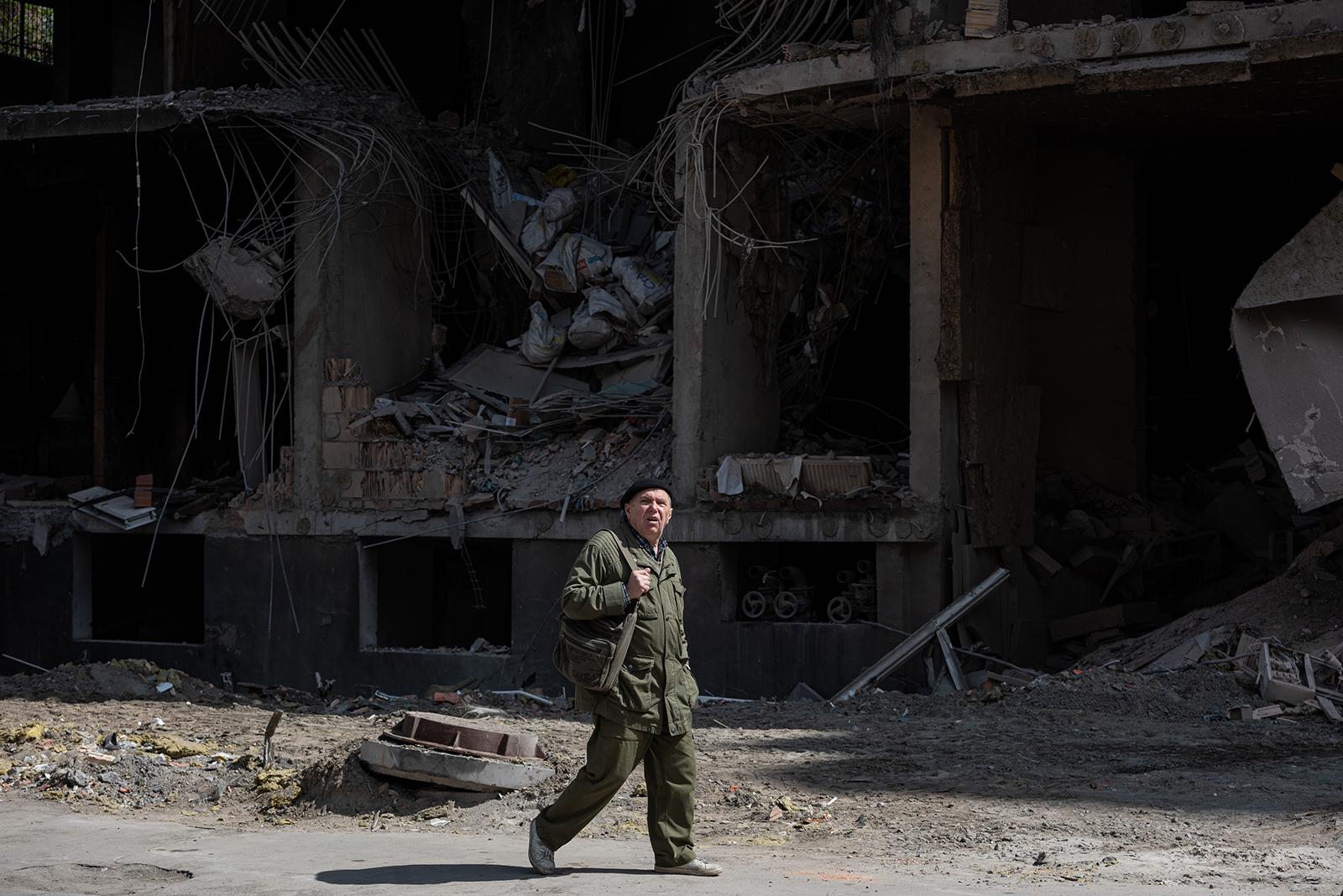 An elderly man walks past a heavily damaged apartment building, on April 30, in Kyiv, Ukraine. 
