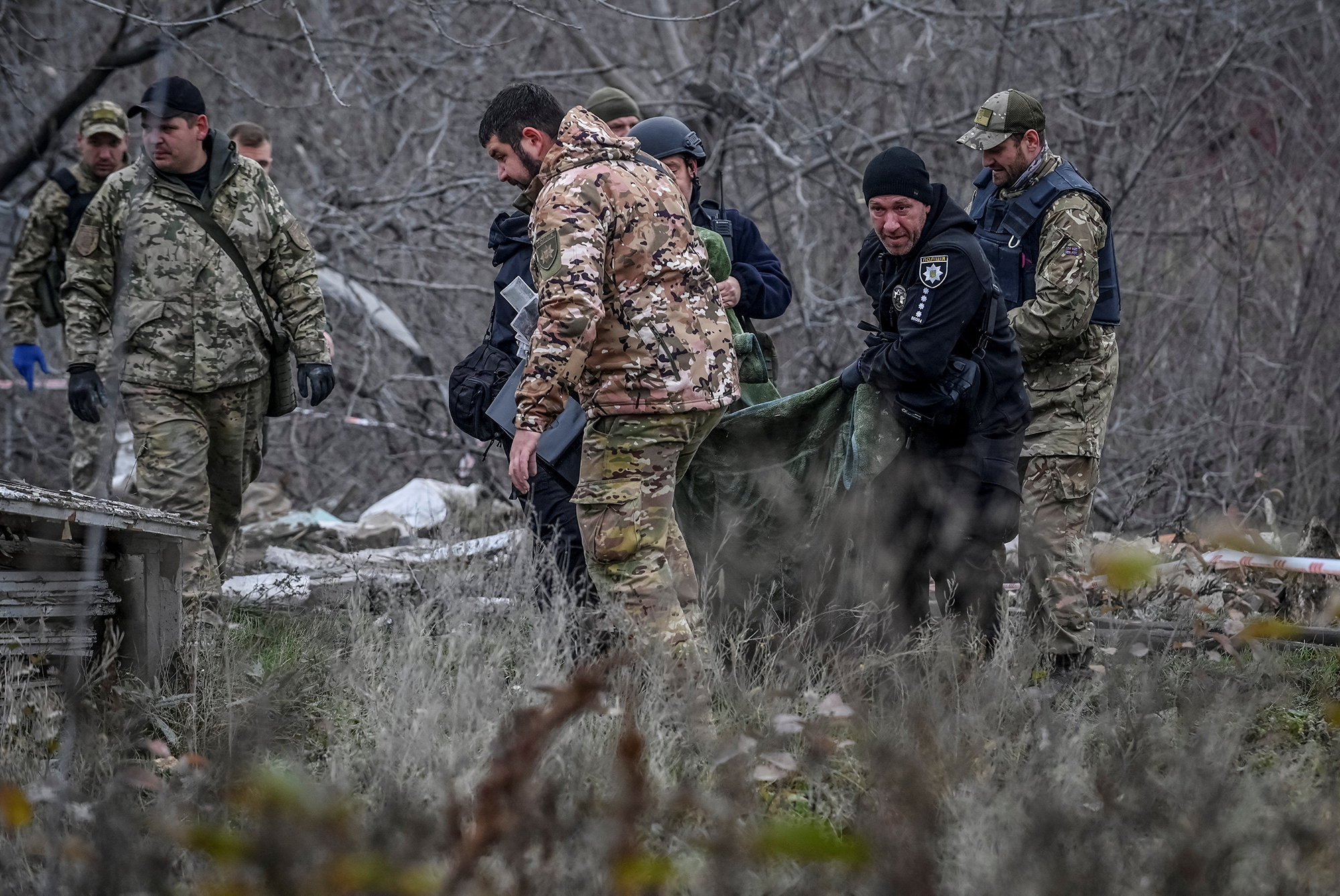 Police officers carry a body that was found under debris of a residential house destroyed by a Russian missile strike in the town of Vilniansk in the Zaporizhzhia region, Ukraine, on November 17.