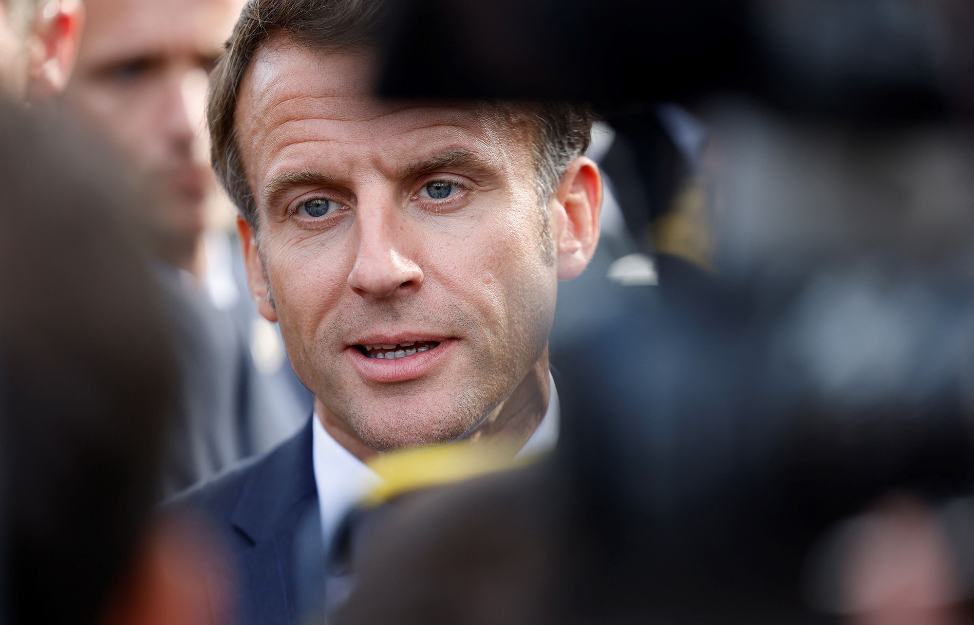 French President Emmanuel Macron speaks to the press during a visit in the city of Craon, northwestern France, on October 10.