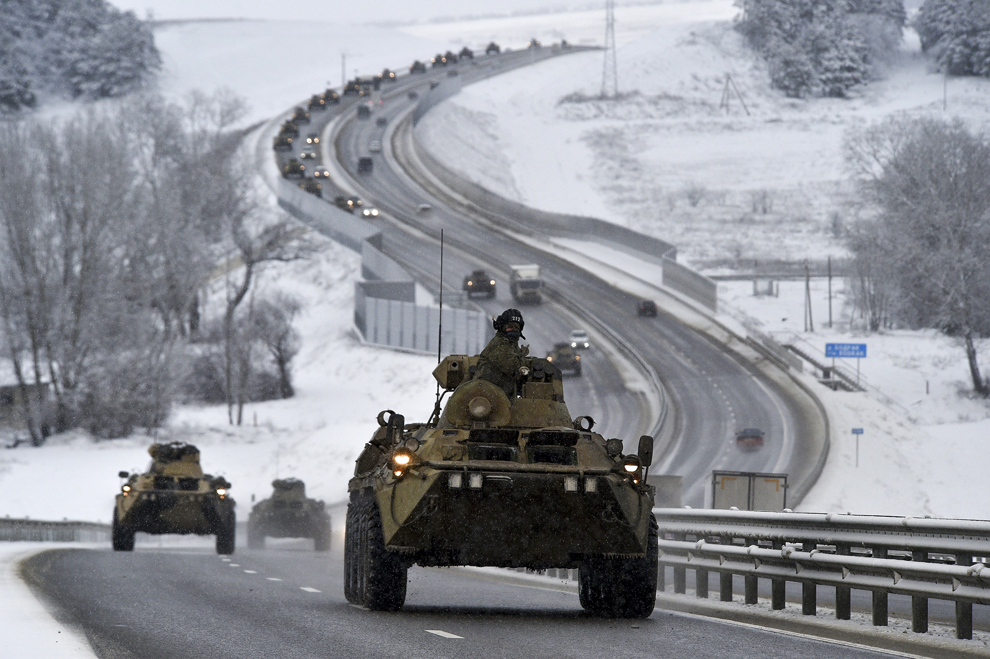 A convoy of Russian armored vehicles moves along a highway in Crimea, Russia on Tuesday, January 18