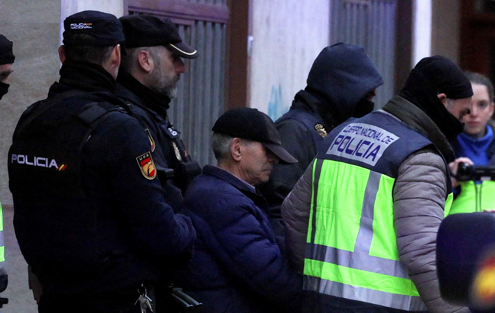 Spanish national police officers lead away a 74-year-old man under arrest on suspicion of being the sender of letter-bombs in November and December to the Ukrainian and U.S. embassies and several institutions in Spain, in Miranda de Ebro, Spain, on January 25.