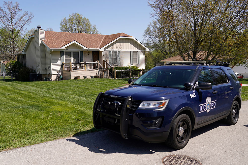 A police officer drives past the house where 16-year-old Ralph Yarl was shot Thursday in Kansas City, Missouri. 