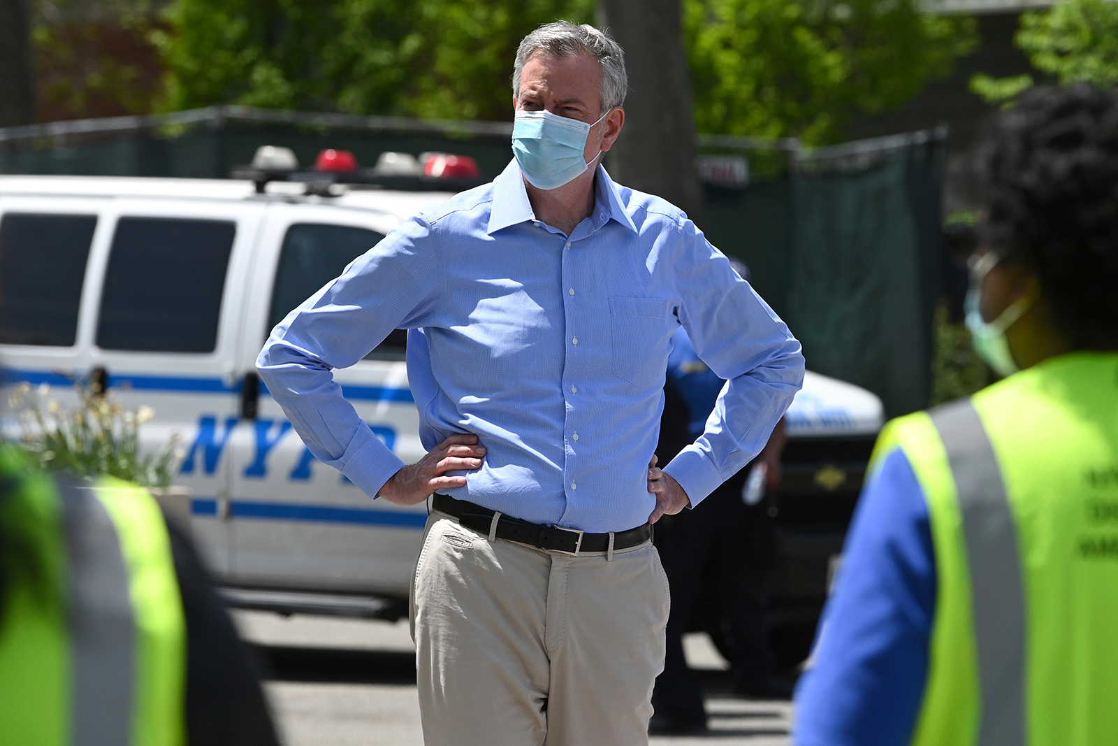 New York City Mayor Bill de Blasio speaks to members of the media before taking a walk through Flushing Meadows Corona Park to hand out free face masks to park goers, in the Queens borough of New York, on Saturday, May 16.