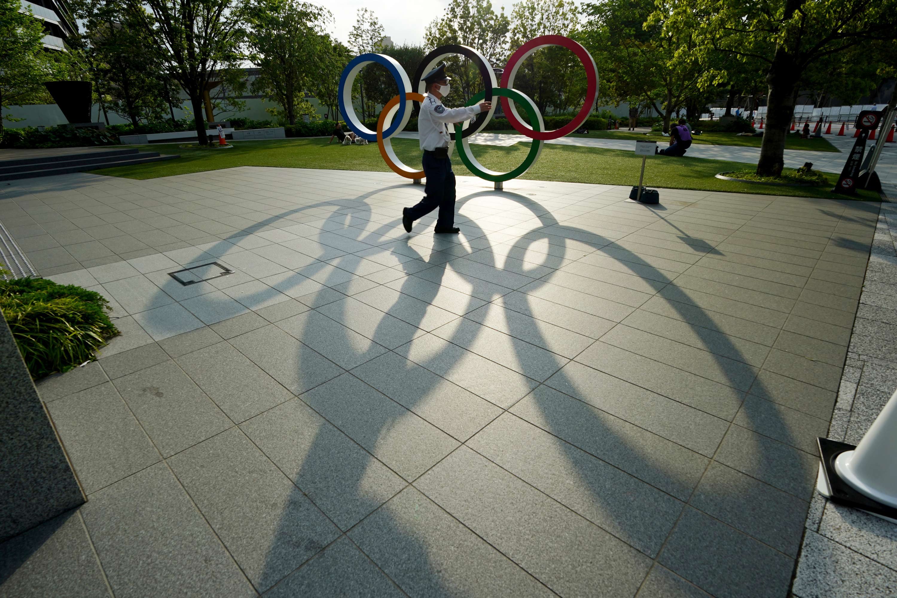 A security guard walks in front of the Olympic Rings on May 9 in Tokyo. 