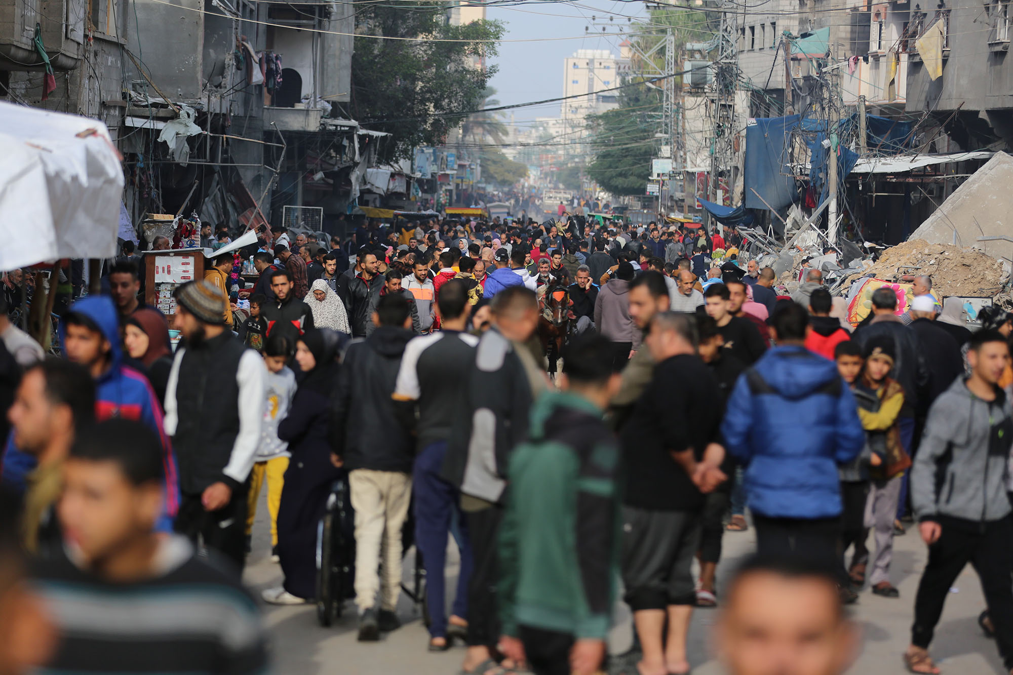 People are seen on a crowded street in Maghazi refugee camp, Gaza, on December 7.
