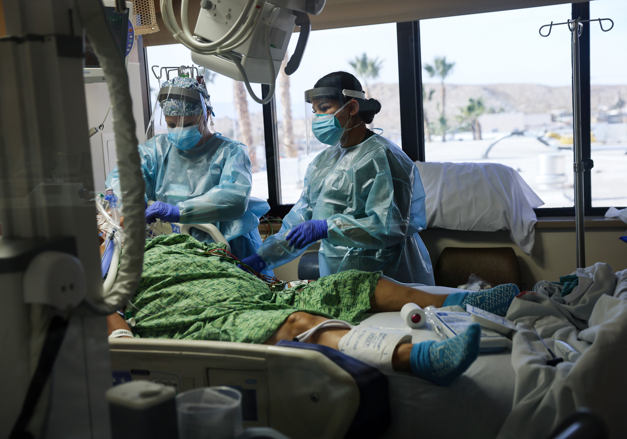 Clinicians care for a COVID-19 patient in the Intensive Care Unit at Providence St. Mary Medical Center on December 23, 2020 in Apple Valley, California.  