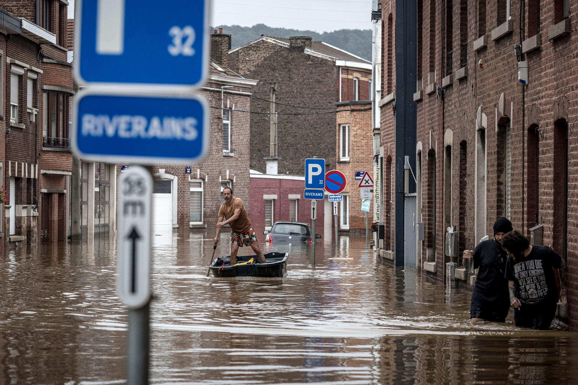 A man rows a boat down a residential street after flooding in Angleur, Province of Liege, Belgium, on July 16.