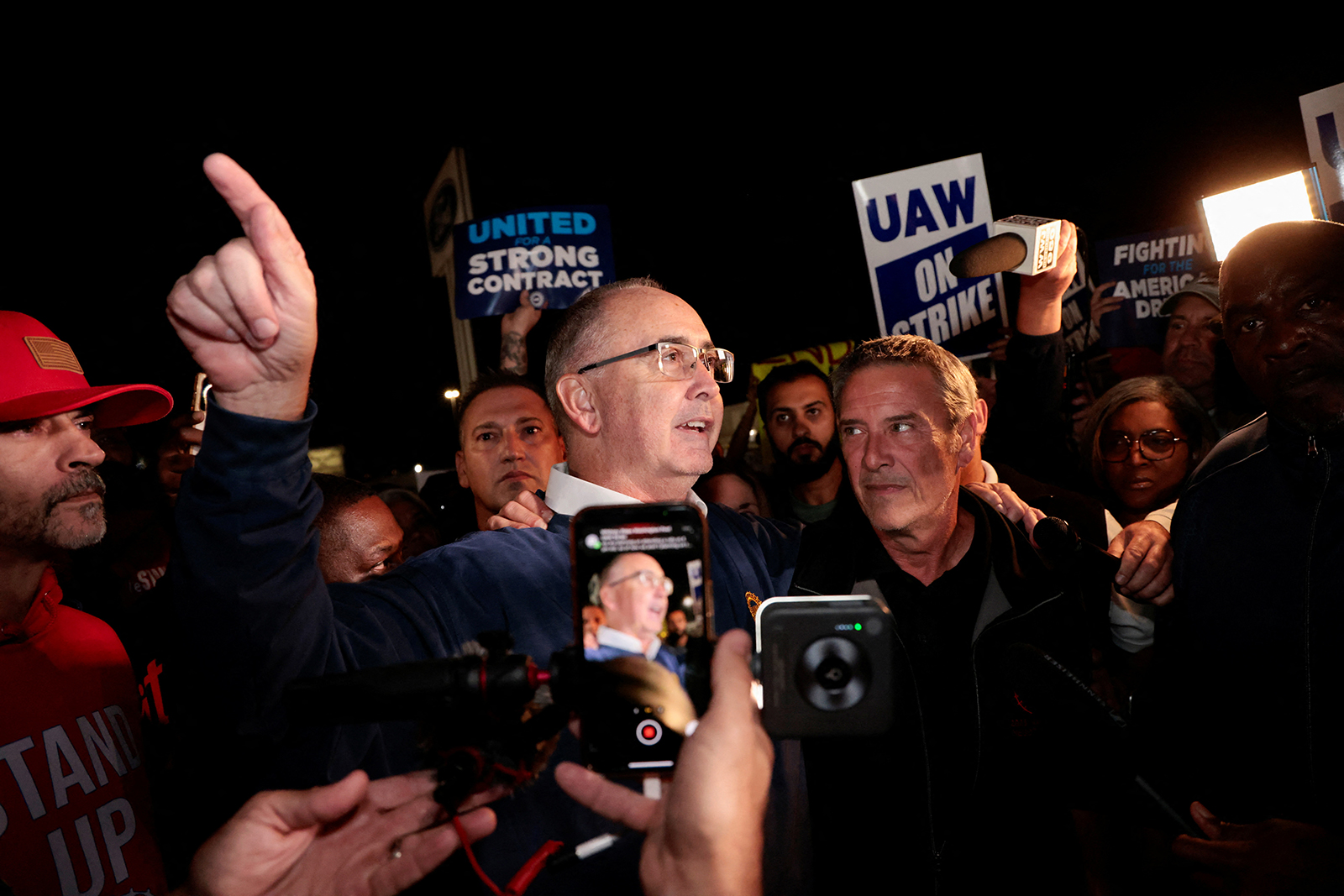 United Auto Workers union President Shawn Fain joins UAW members who are on a strike at the Ford Michigan assembly plant in Wayne, Michigan, on the morning of September 15.
