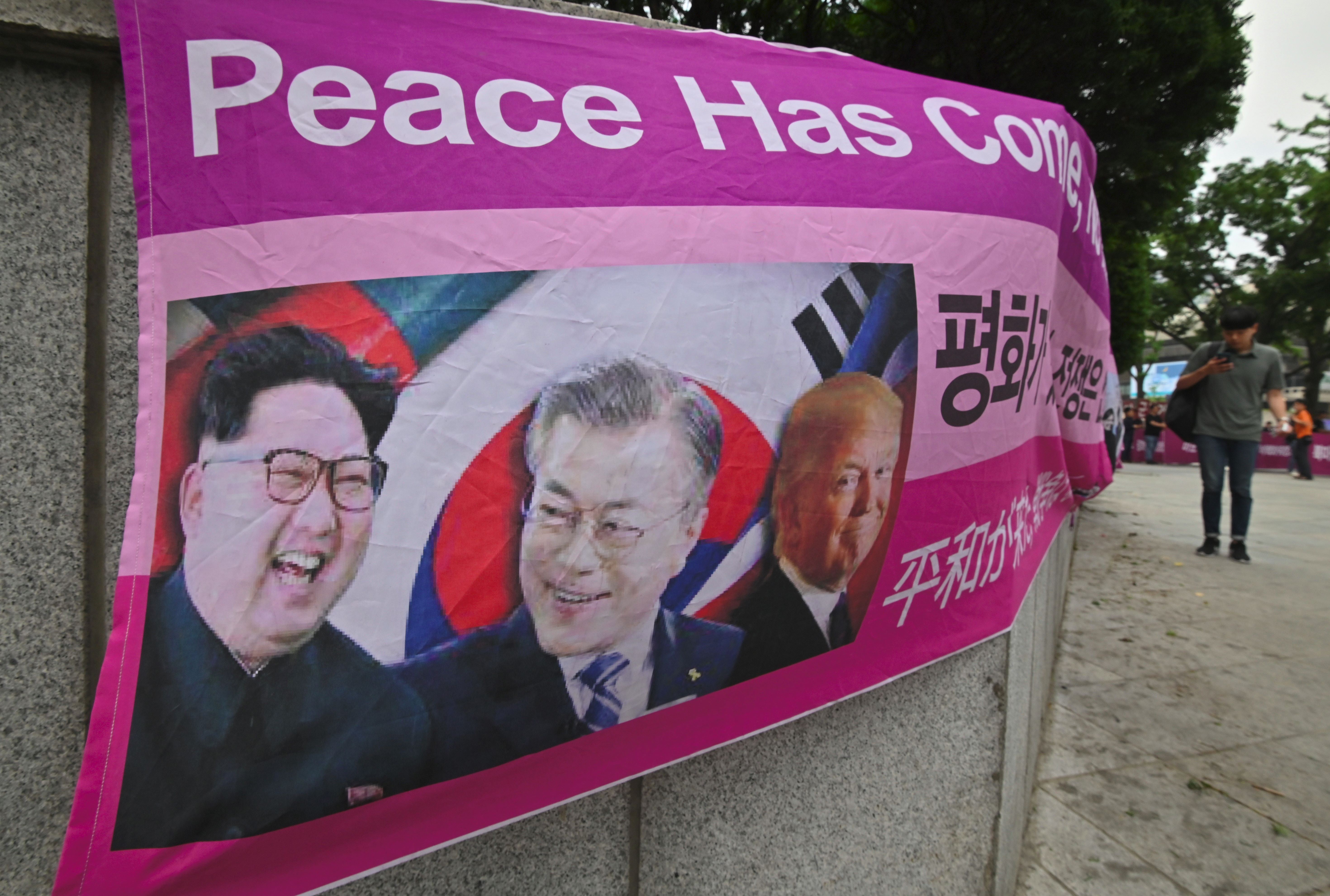 A banner showing pictures of (L-R) North Korean leader Kim Jong Un, South Korean President Moon Jae-in and US President Donald Trump in Seoul, on June 29.