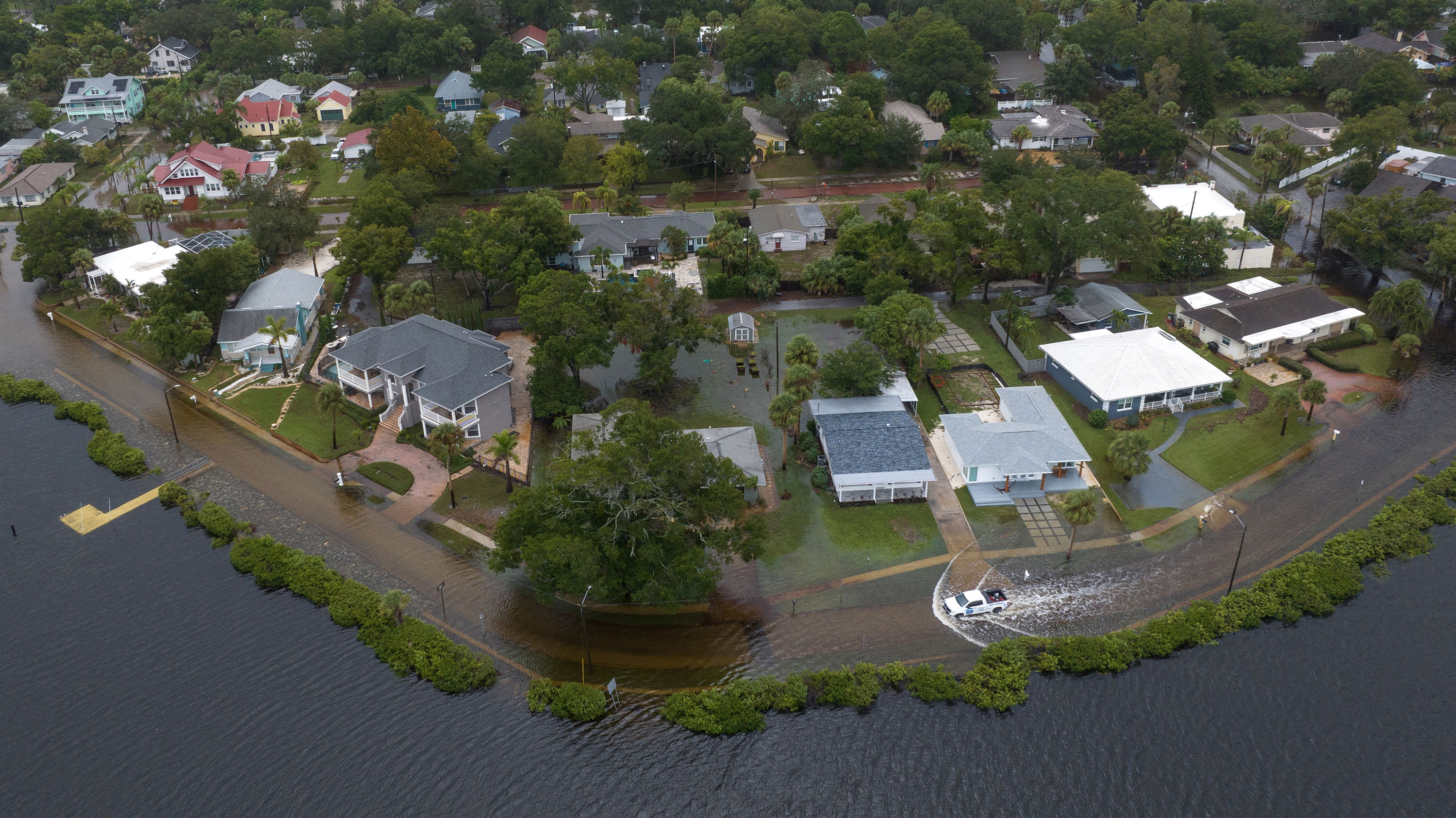 A vehicle moves through flood waters in the aftermath of Hurricane Idalia in Tarpon Springs, Florida, on Wednesday. 