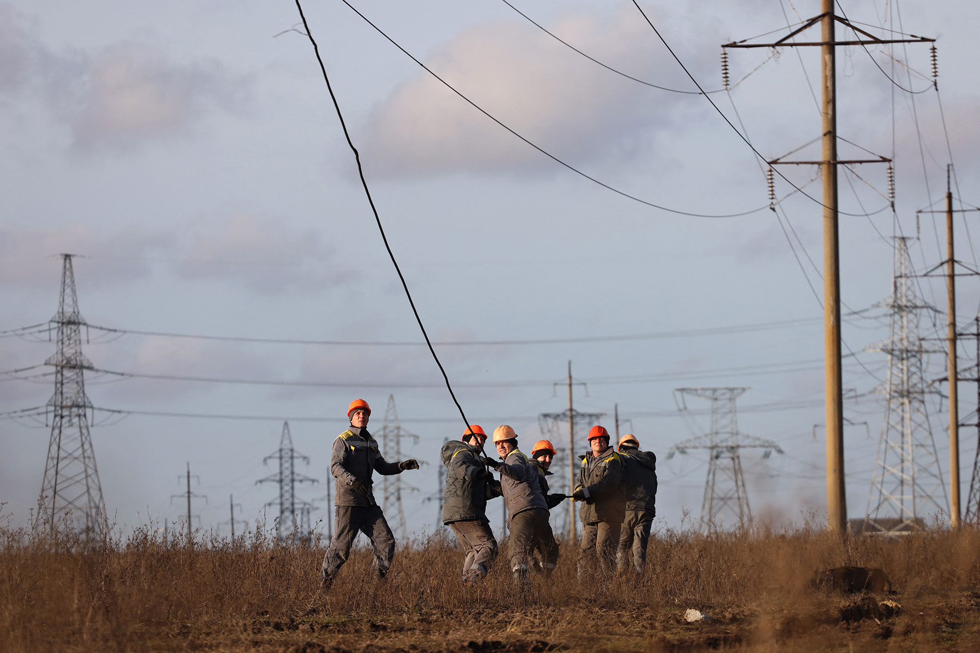 Workers repair high-voltage power lines damaged by recent missile strikes near Odessa, Ukraine, on December 29.