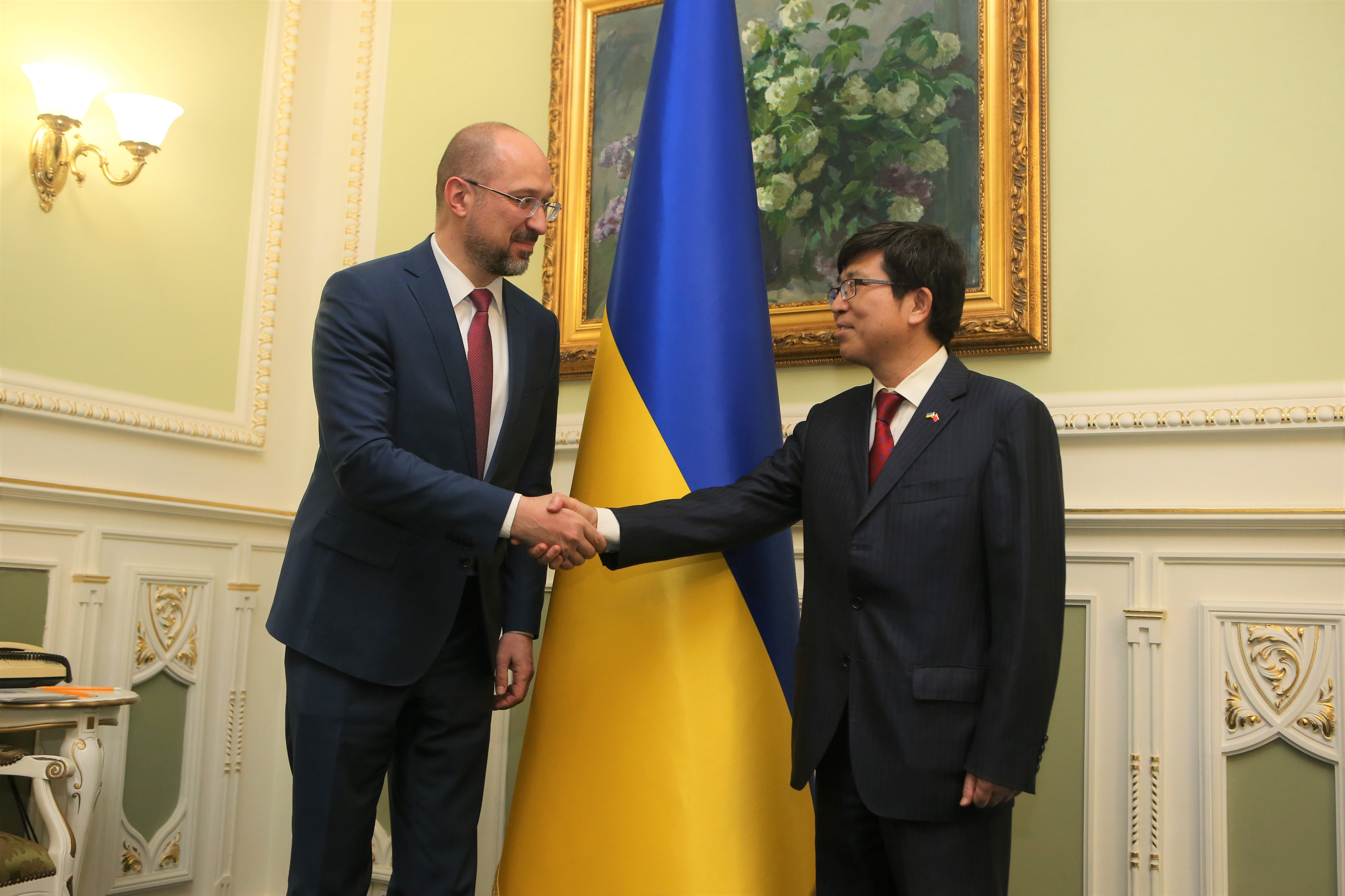 In this file photo, Ukrainian Prime Minister Denys Shmygal, left, shakes hands with Chinese Ambassador to Ukraine Fan Xianrong in Kyiv, Ukraine, on March 18, 2020.