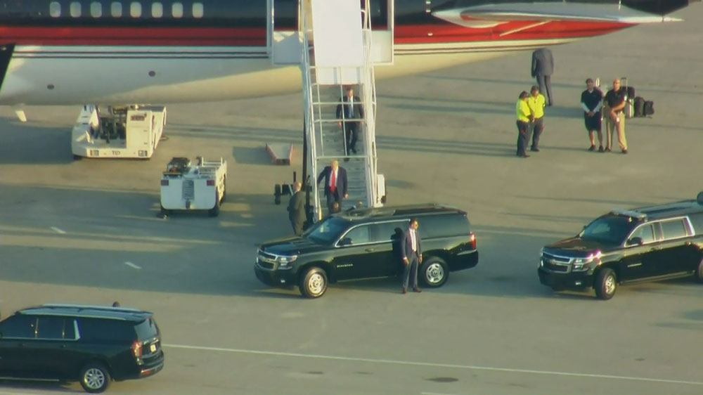 Trump departs his plane as he arrives in Florida.
