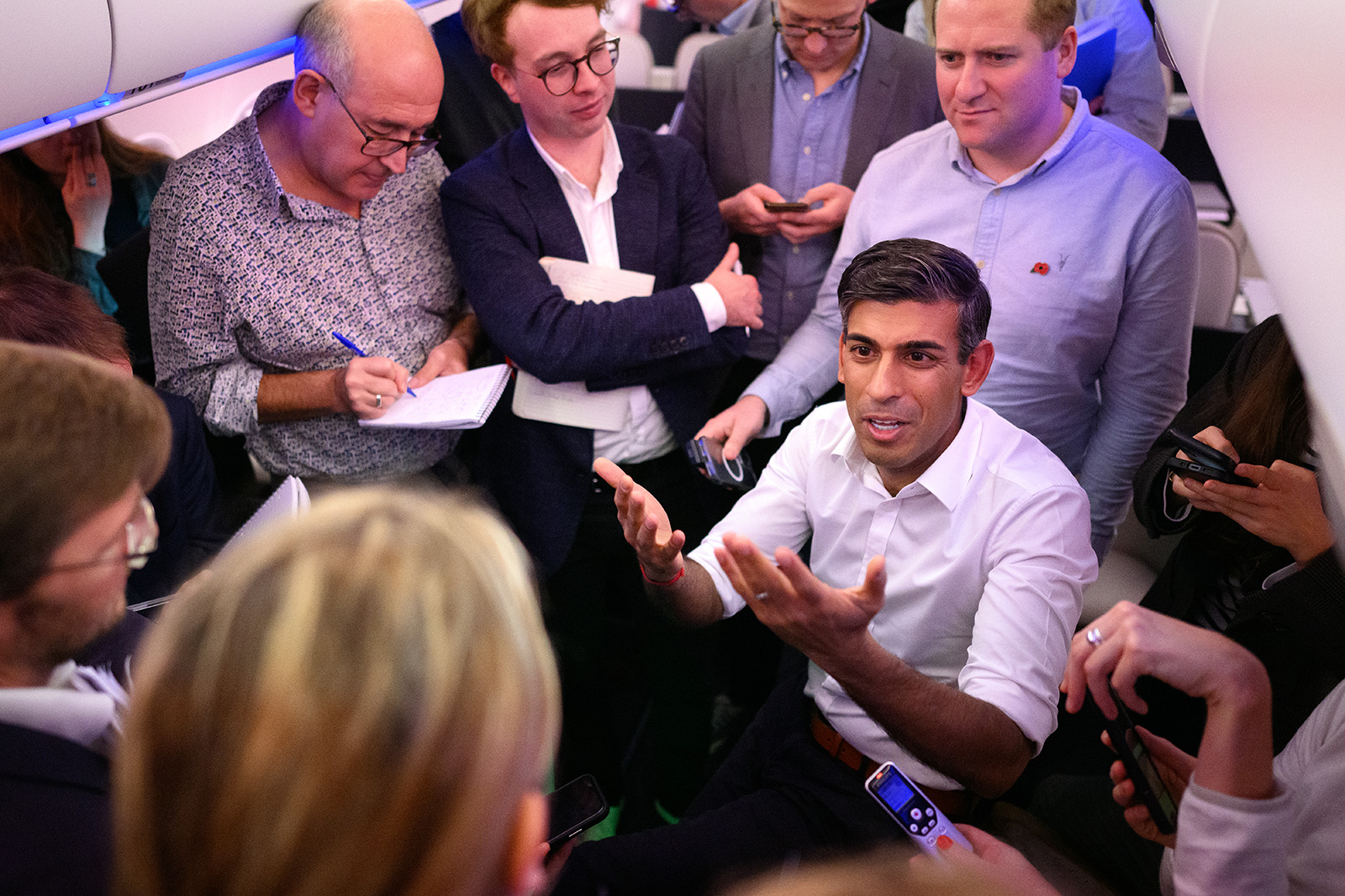 British Prime Minister Rishi Sunak speaks with political journalists on board a government airplane inflight to Indonesia, on November 13.