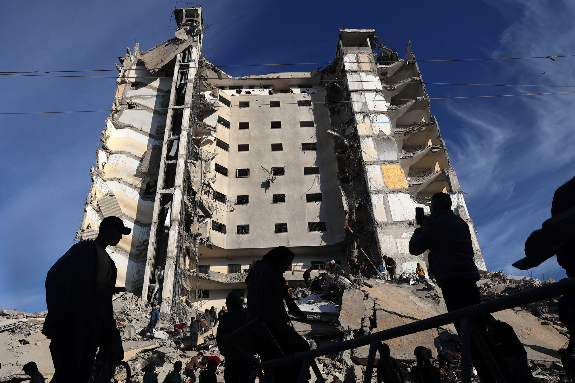 Palestinians gather in front of a residential building hit in an overnight Israeli air strike in Rafah, Gaza, on March 9. 