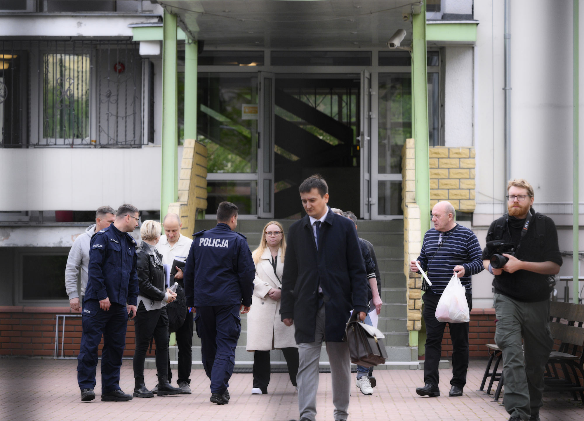 Police and city authorities are seen at the Russian embassy school in Warsaw on Saturday.