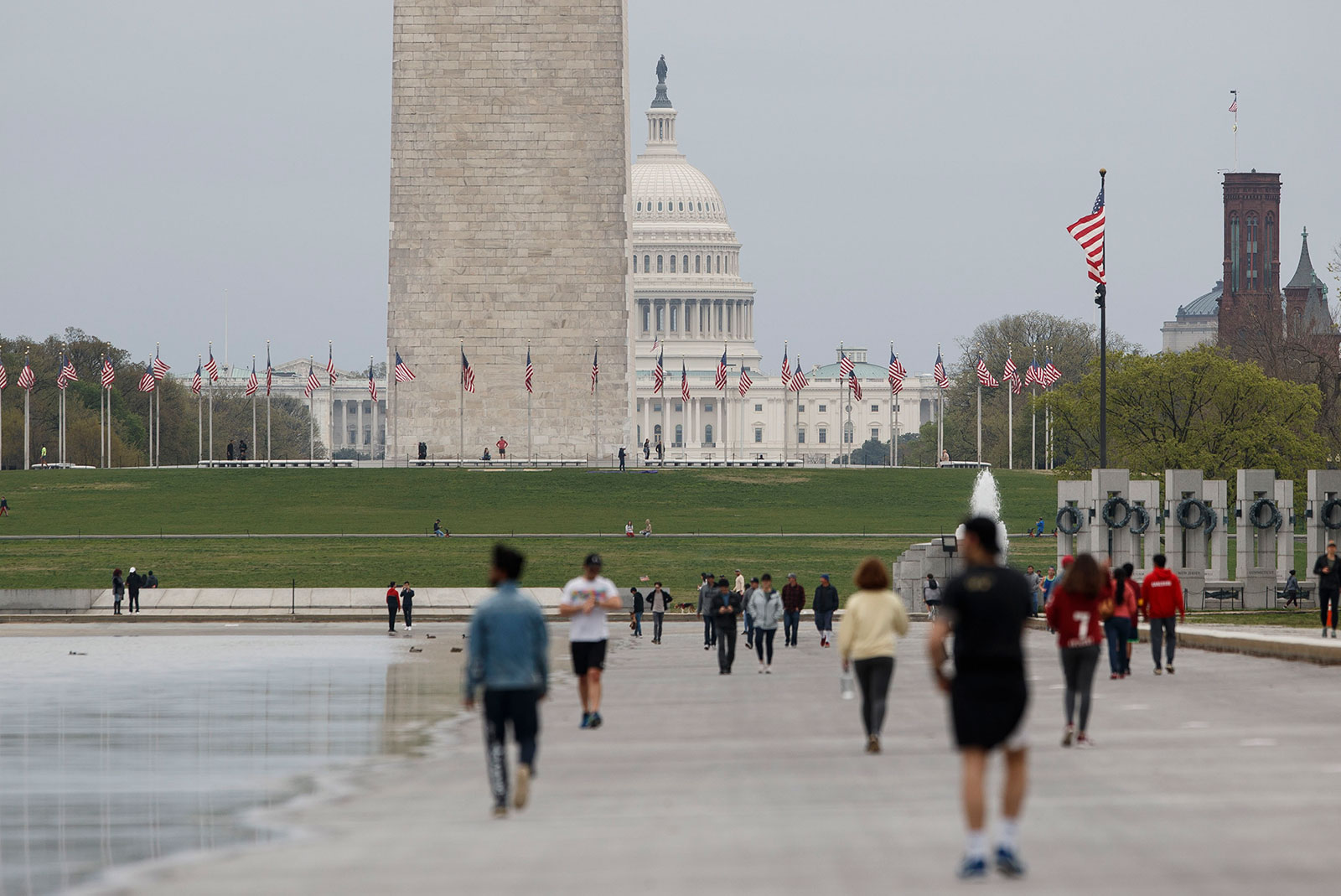 People walk along the National Mall in Washington, DC, on March 28.