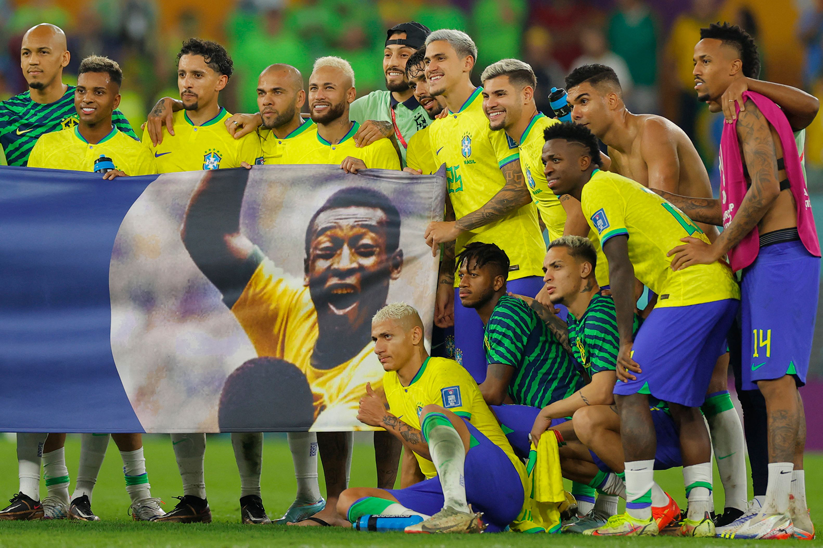 Brazil players stand behind a banner honoring Brazilian football legend Pele after they won the Qatar 2022 World Cup round of 16 football match between Brazil and South Korea at Stadium 974 in Doha on December 5.