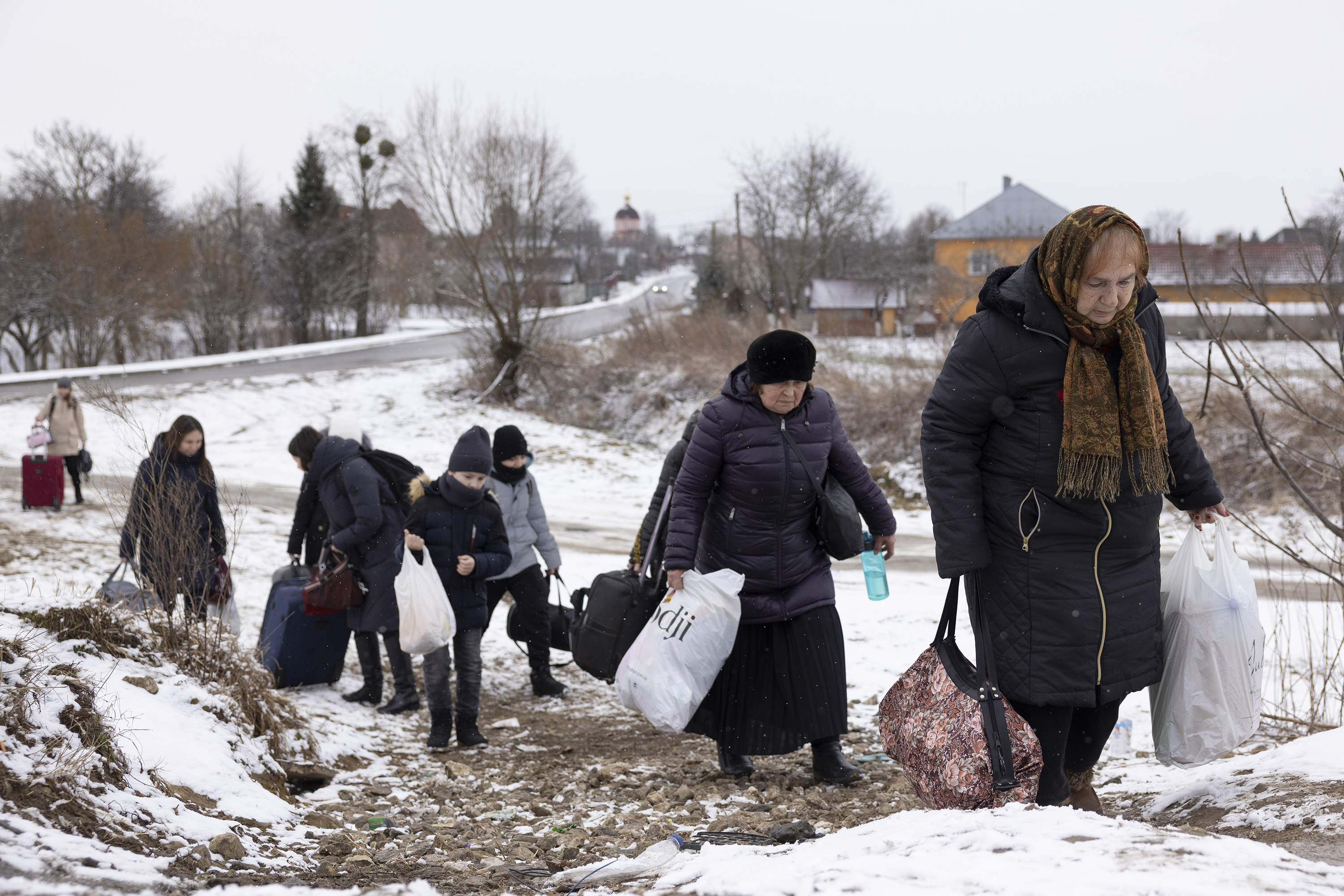 Refugees fleeing conflict make their way to the border crossing with Poland on March 9 in Krakovets, Ukraine. 