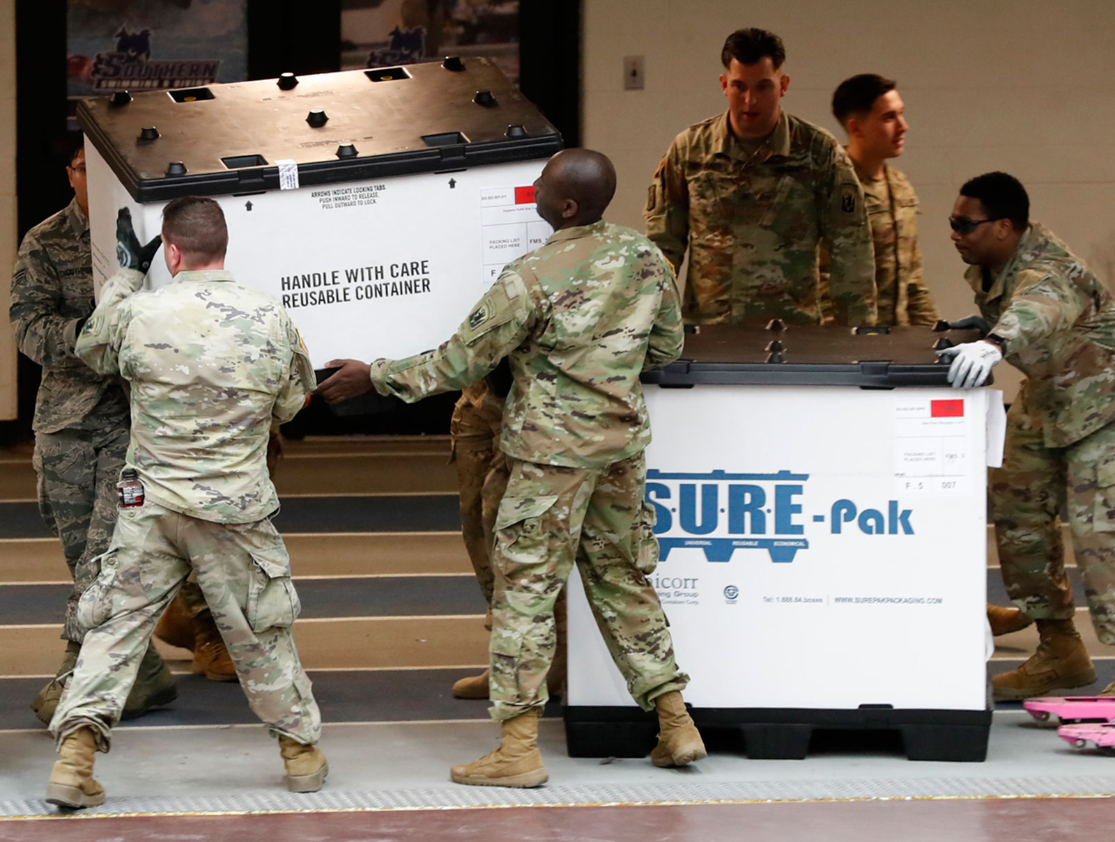 Members of the Connecticut Air and Army National Guard unload supplies for a temporary field hospital at Southern Connecticut State University on March 31 in New Haven, Connecticut.