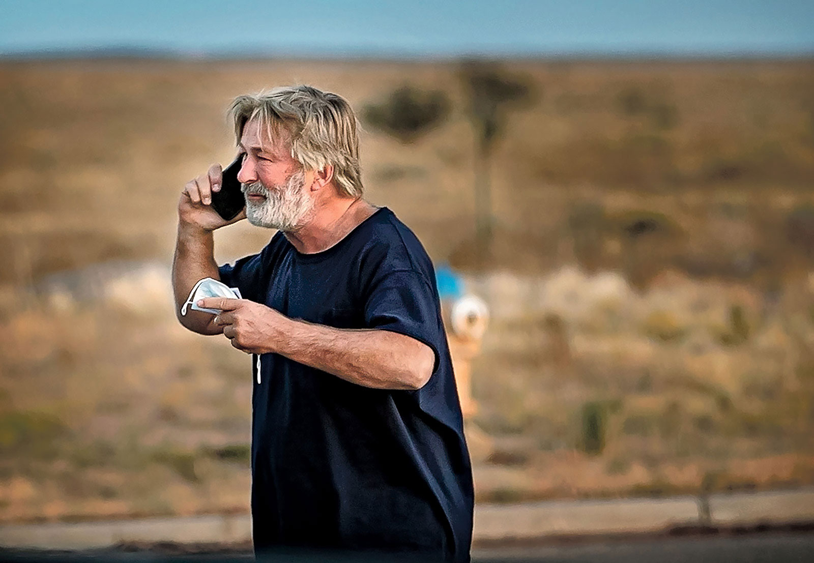 A distraught Alec Baldwin speaks on the phone in the parking lot outside the Santa Fe County sheriff's offices after being questioned Thursday about a shooting on a local movie set.