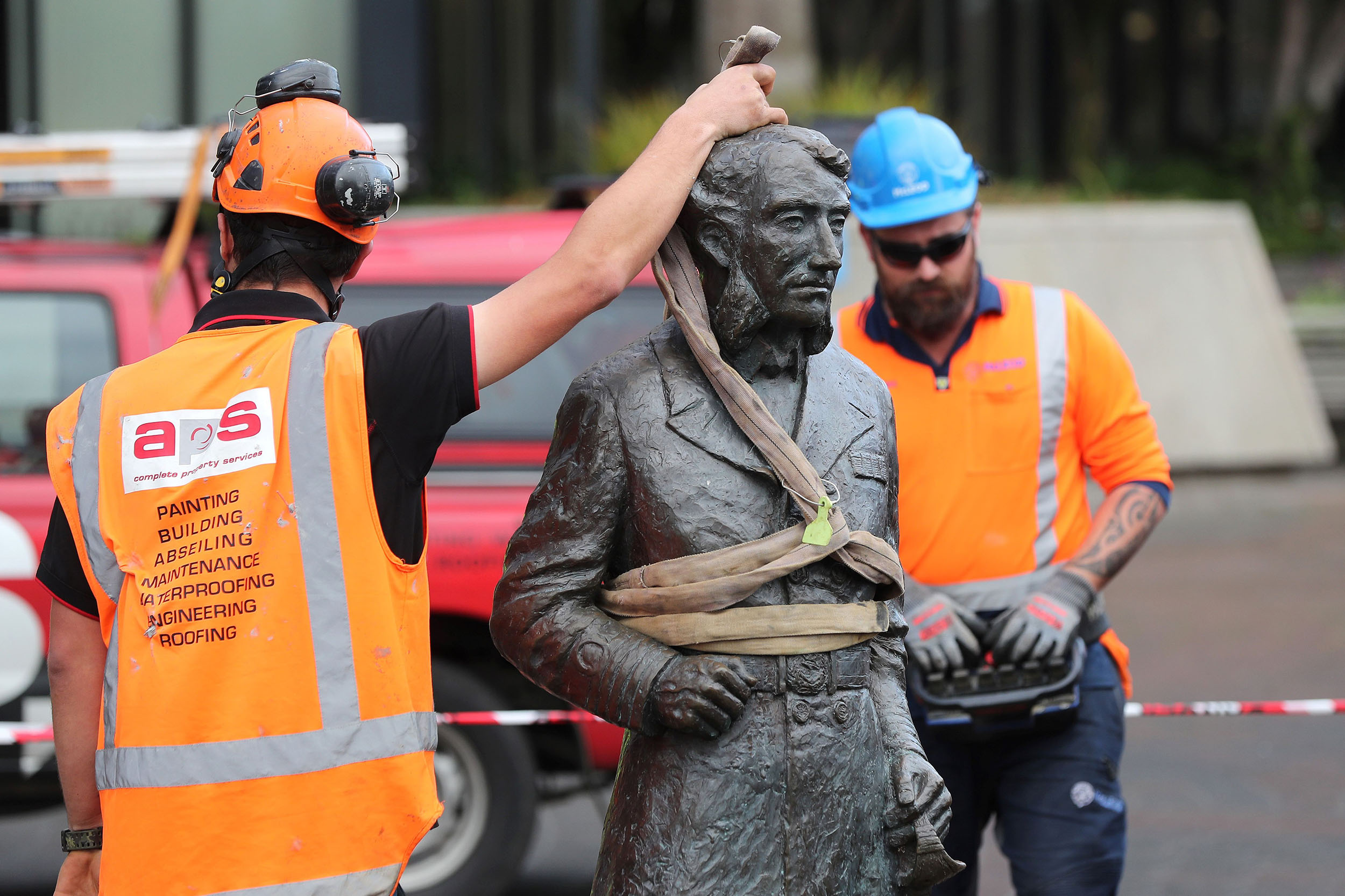 Workers remove a controversial statue of Captain John Fane Charles Hamilton from Civic Square in Hamilton, New Zealand, on June 12. 