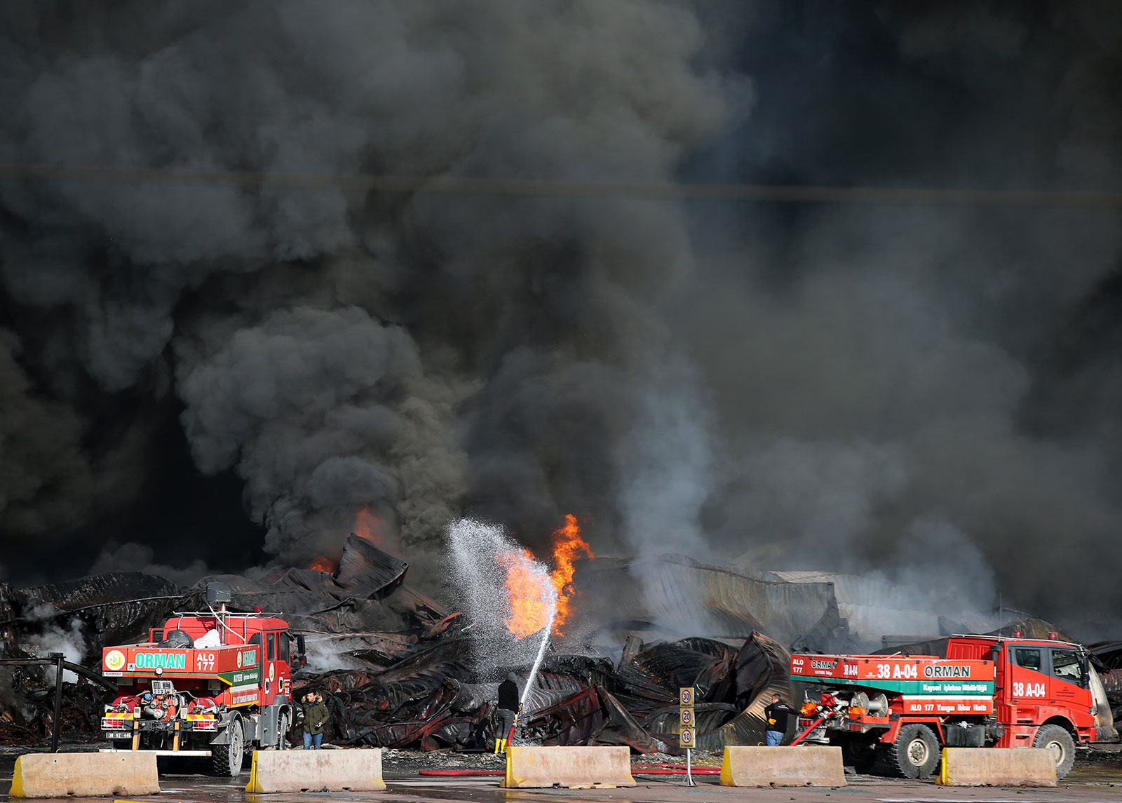 Fire trucks continue to extinguish flames at Iskenderun port on Thursday. 