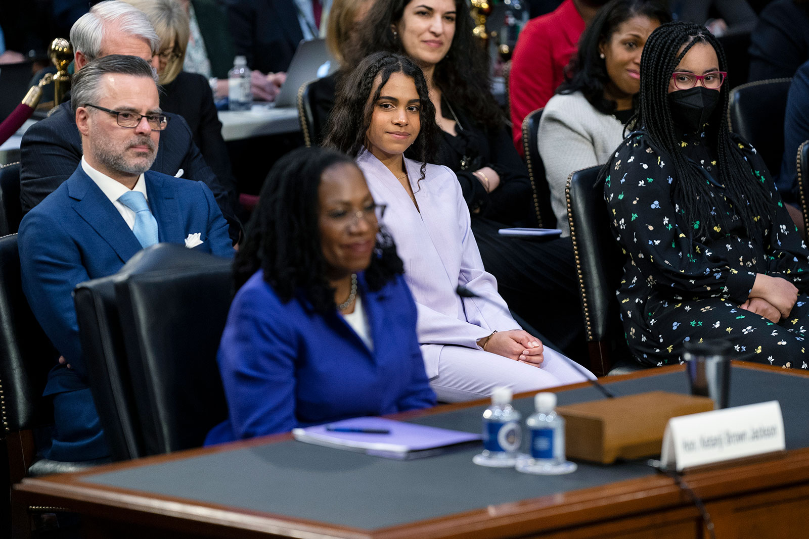 Supreme Court nominee Judge Ketanji Brown Jackson's husband Patrick and their daughters Leila and Talia listen during her opening statements. 