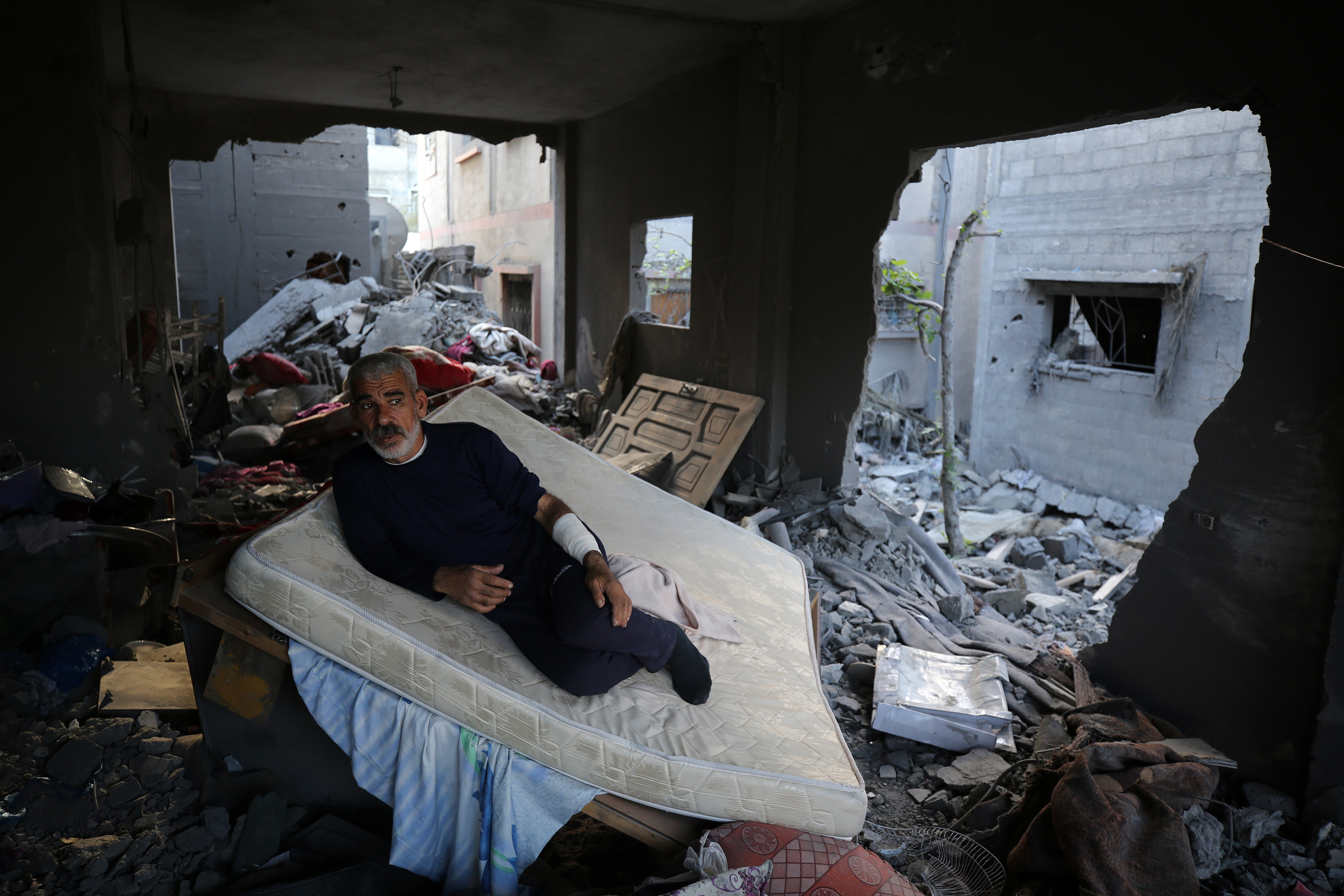 A Palestinian man sits in his home destroyed during the Israeli bombardment of Gaza, in Deir al-Balah, in the central Gaza Strip on November 15.