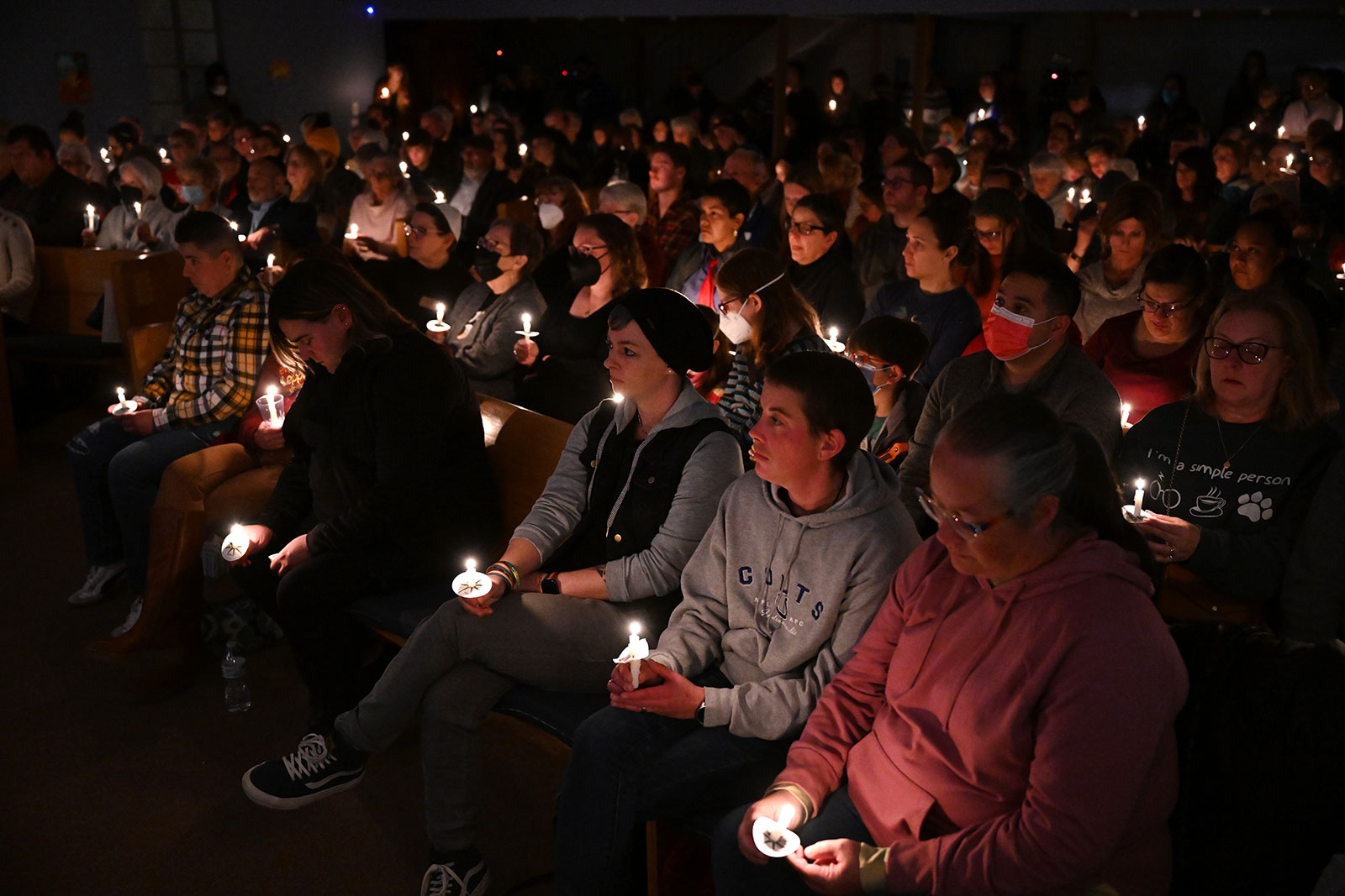 Mourners hold candles during a candlelight vigil and interfaith service at Temple Beit Torah on November 20, in honor of the lives that were lost at Club Q in Colorado Springs, Colorado. 