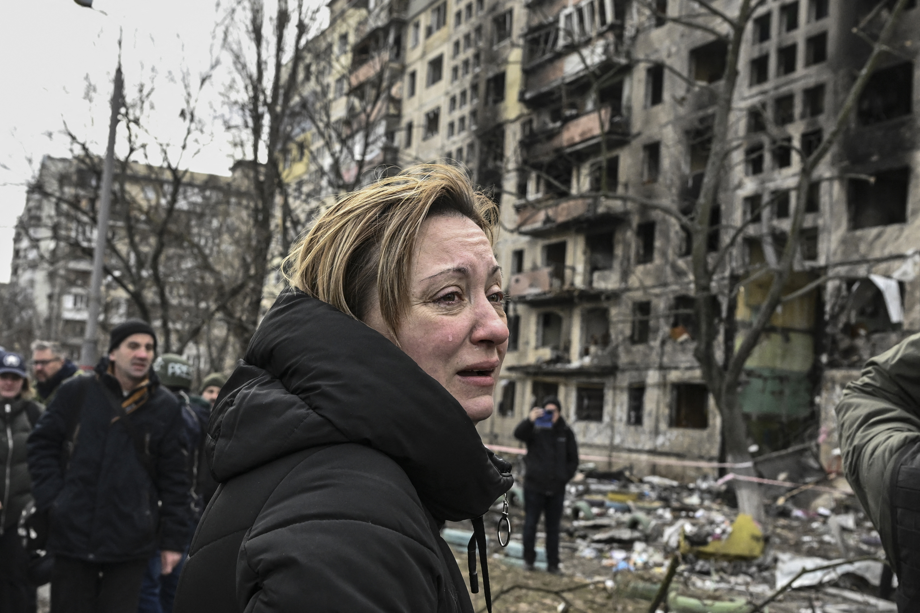 A woman reacts as she stands outside destroyed apartment blocks following shelling in the northwestern Obolon district of Kyiv, Ukraine, on March 14.