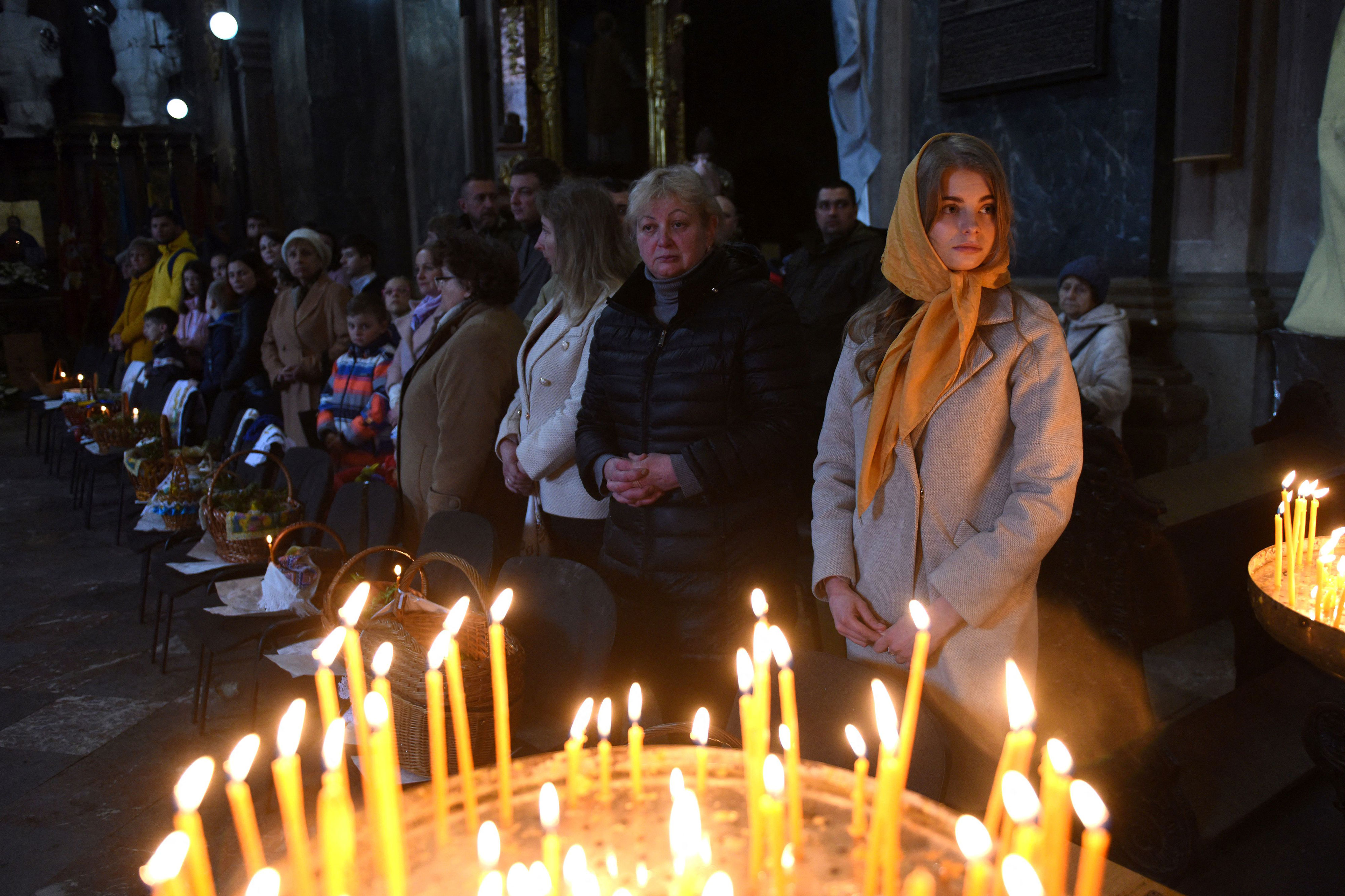 Worshippers attend a service marking Orthodox Easter at Saints Peter and Paul Garrison Church, in Lviv, on Saturday, April 23. Ukrainian authorities urged those celebrating Orthodox Easter to follow religious services online and to respect curfews amid fighting with Russian troops despite a holiday that usually attracts crowds. 