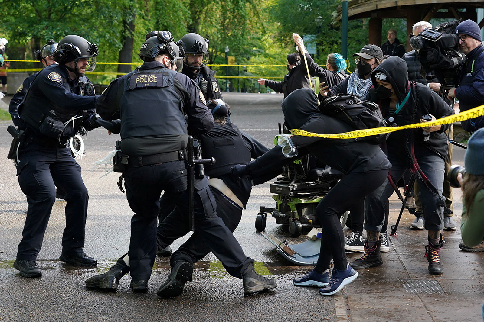 Police arrest a protester, who ran from the Portland State University library building, in Portland on Thursday.