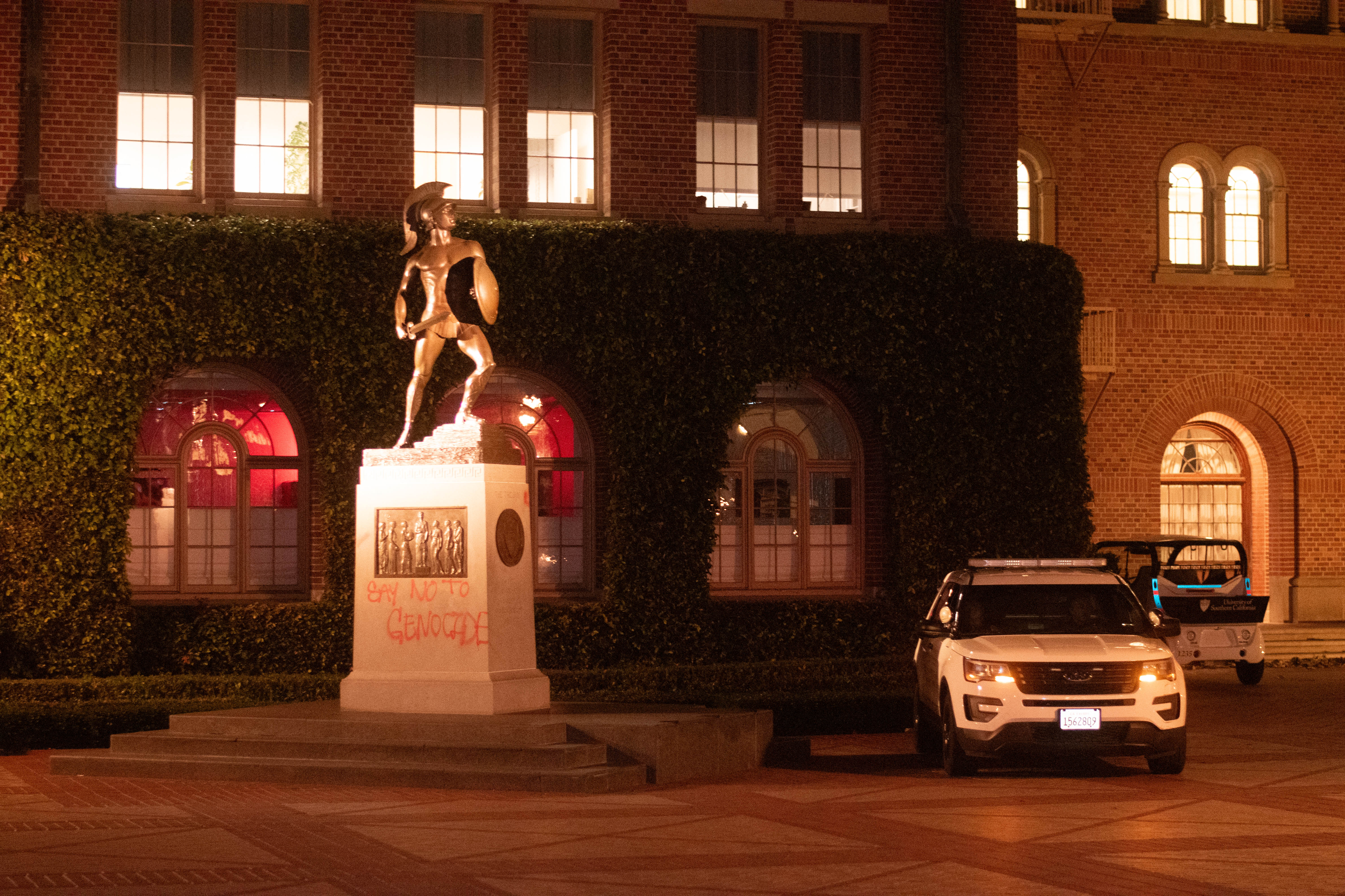 A USC Department of Public Safety vehicle sits next to the base of the Tommy Trojan statue that was tagged in Hahn Plaza at the University of Southern California, Los Angeles, on April 28, 2024.