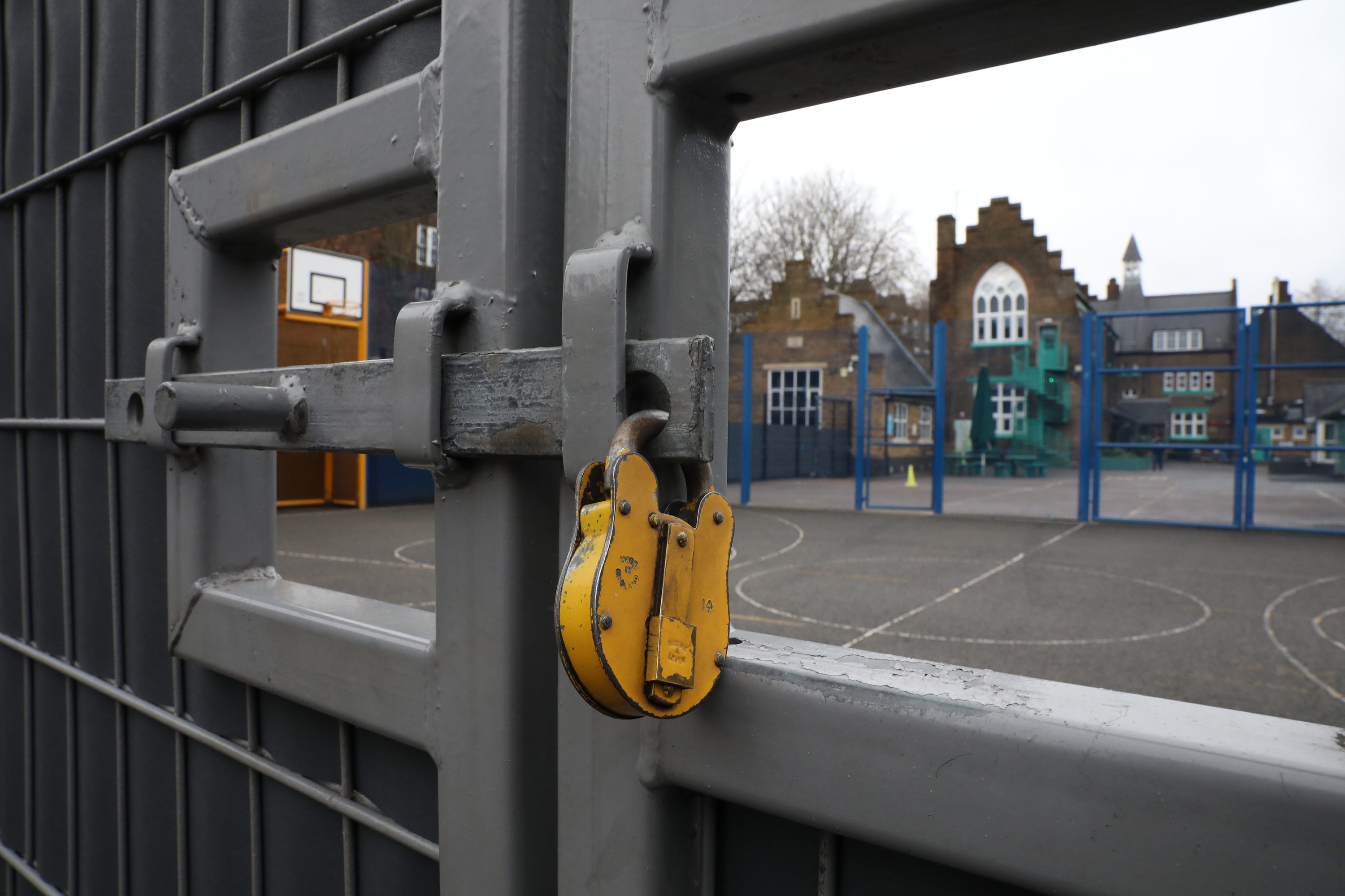 A lock hangs on a primary school gate on January 4 in London, England. 