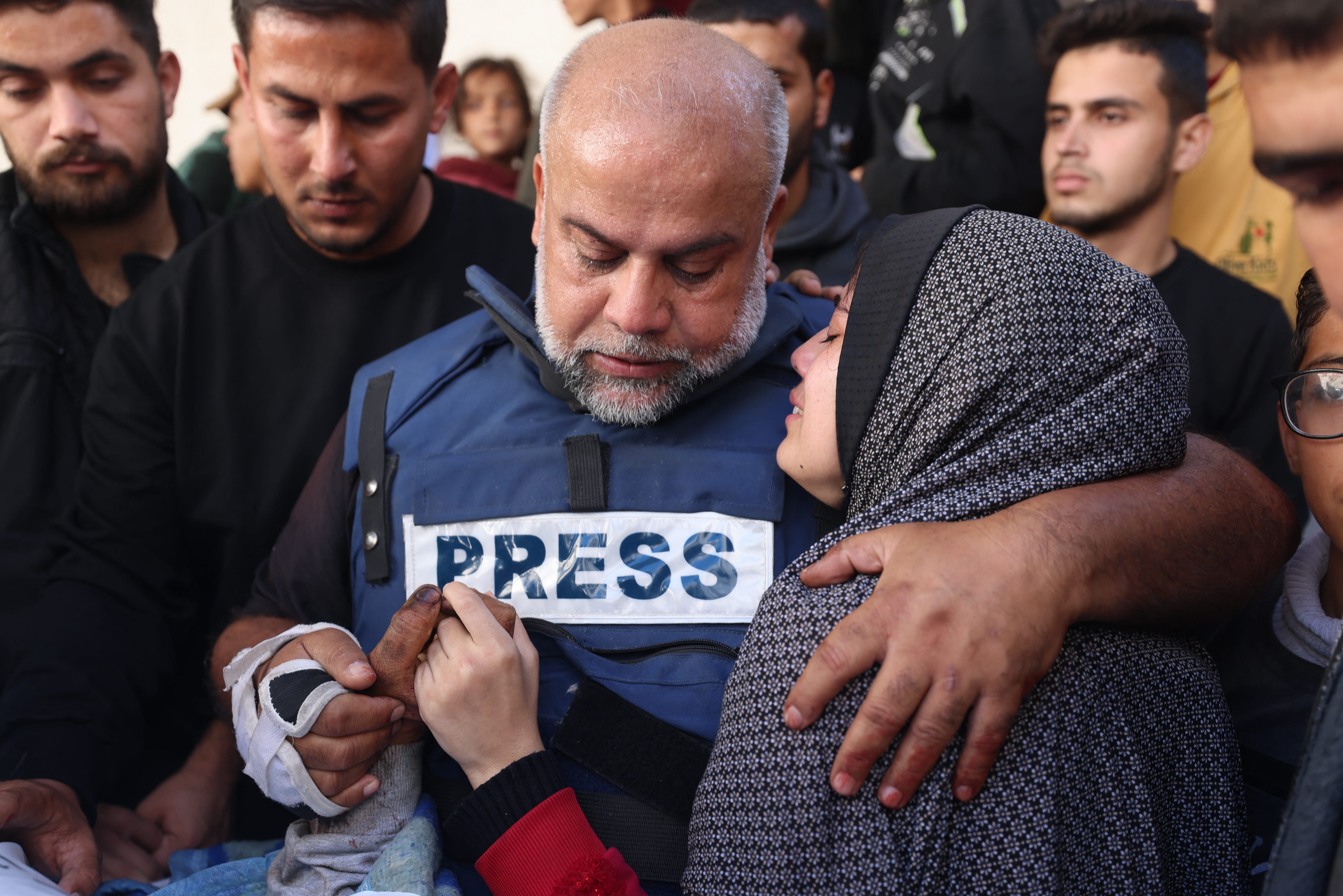 Al Jazeera Gaza bureau chief Wael Al-Dahdouh hugs his daughter during the funeral for his son Hamza Wael Al-Dahdouh in Rafah, Gaza, on January 7.