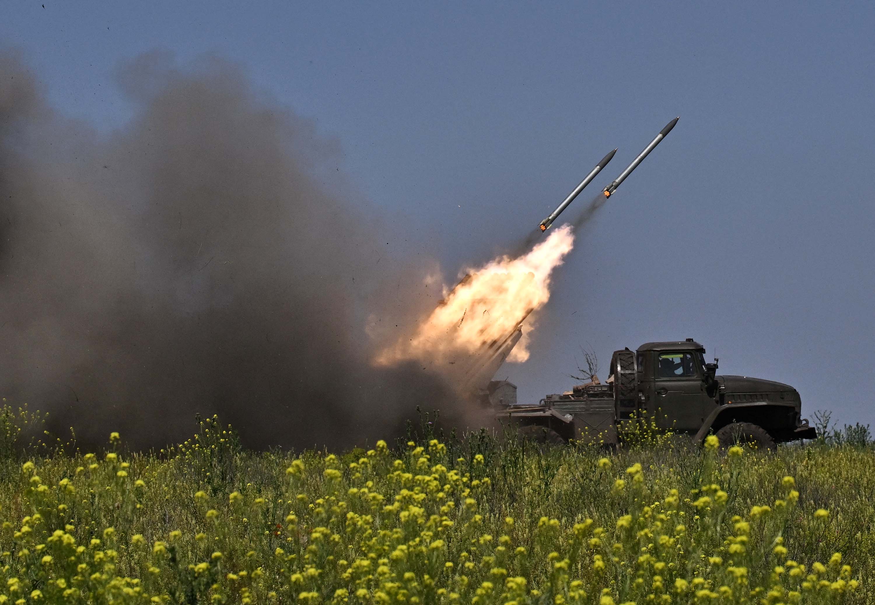 Ukrainian servicemen fire a BM-21 'Grad' multiple rocket launcher towards Russian positions at a front line near Bakhmut, in Ukraine's Donetsk region, on June 20. 