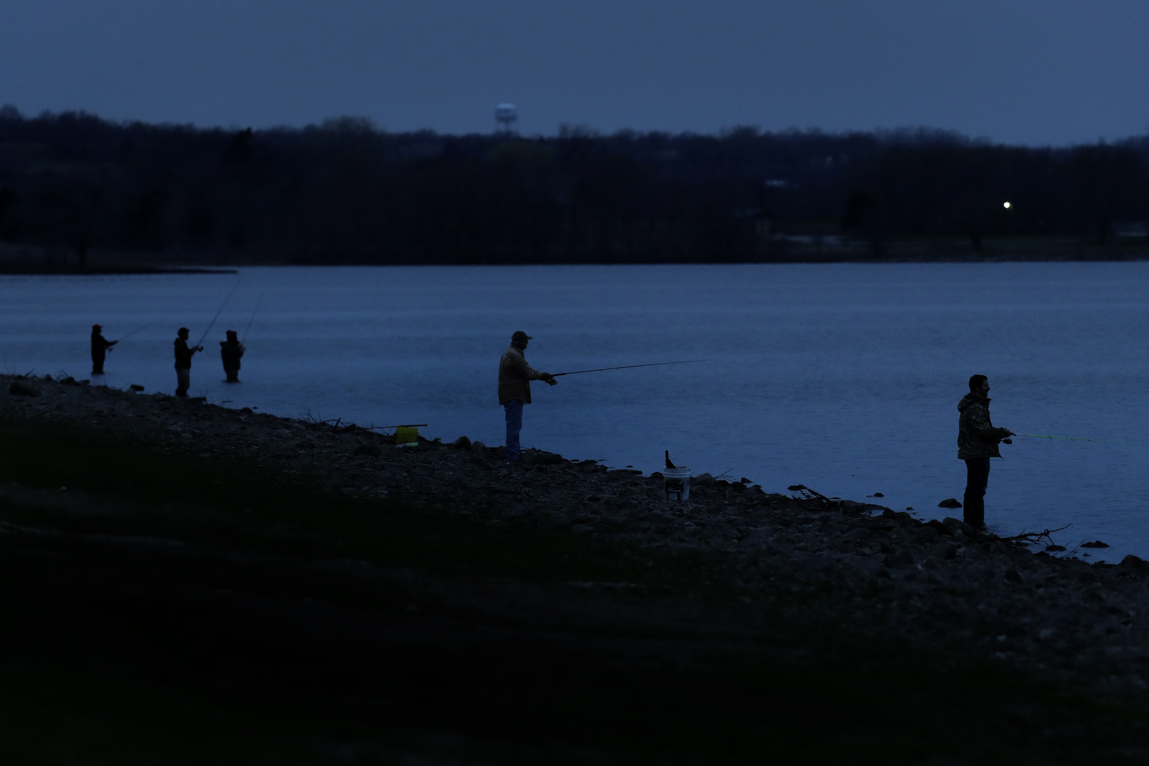 People maintain their distance as they fish at Hillsdale Lake near Hillsdale, Kansas, on March 30.