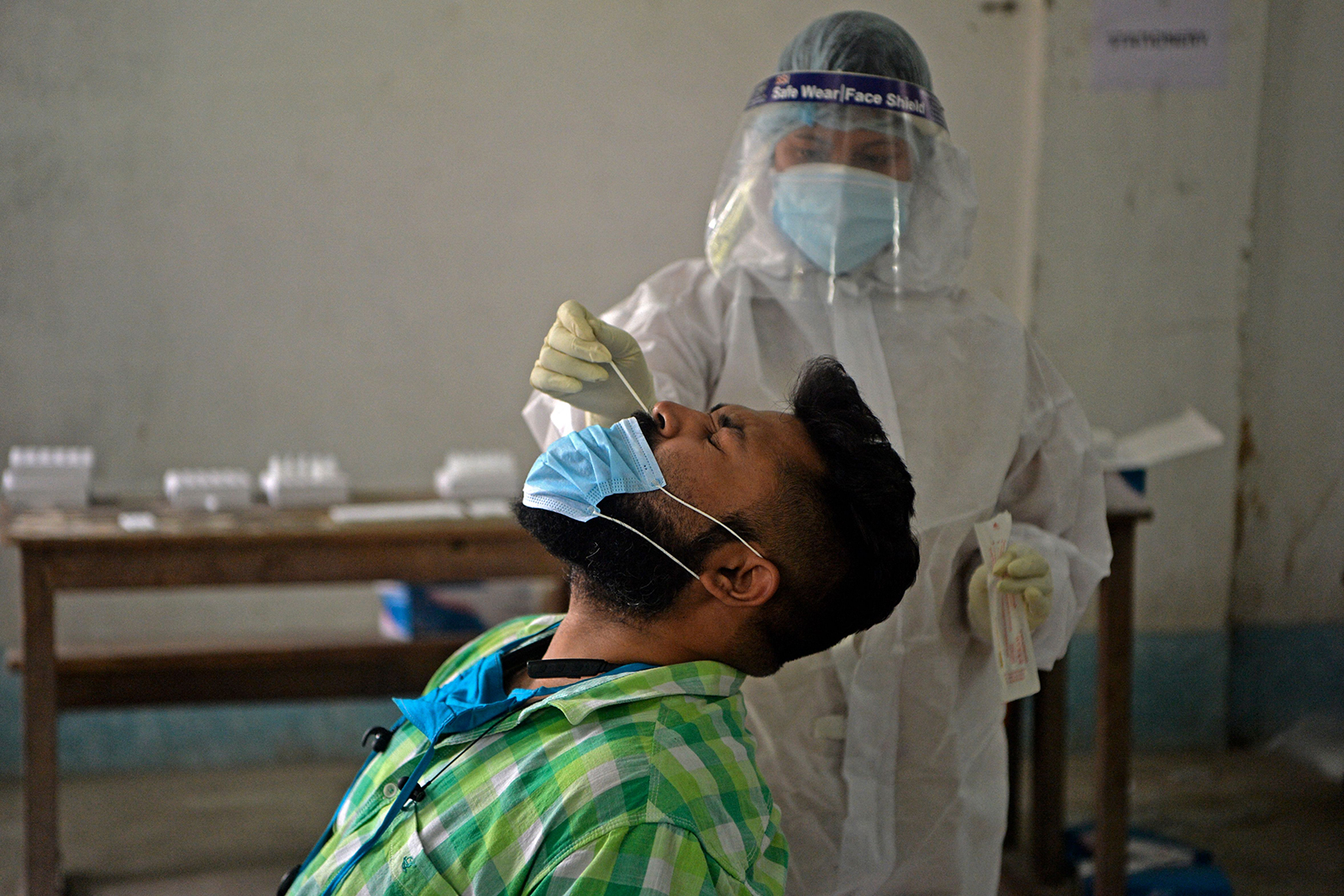 A health worker collects a nasal swab sample at Siliguri college in Siliguri, India, on April 30.