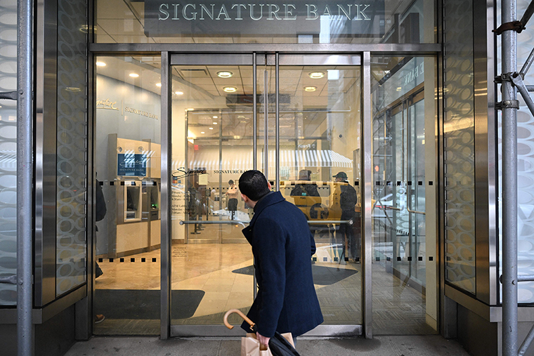 A man walks past a branch of Signature Bank in New York city on March 13.