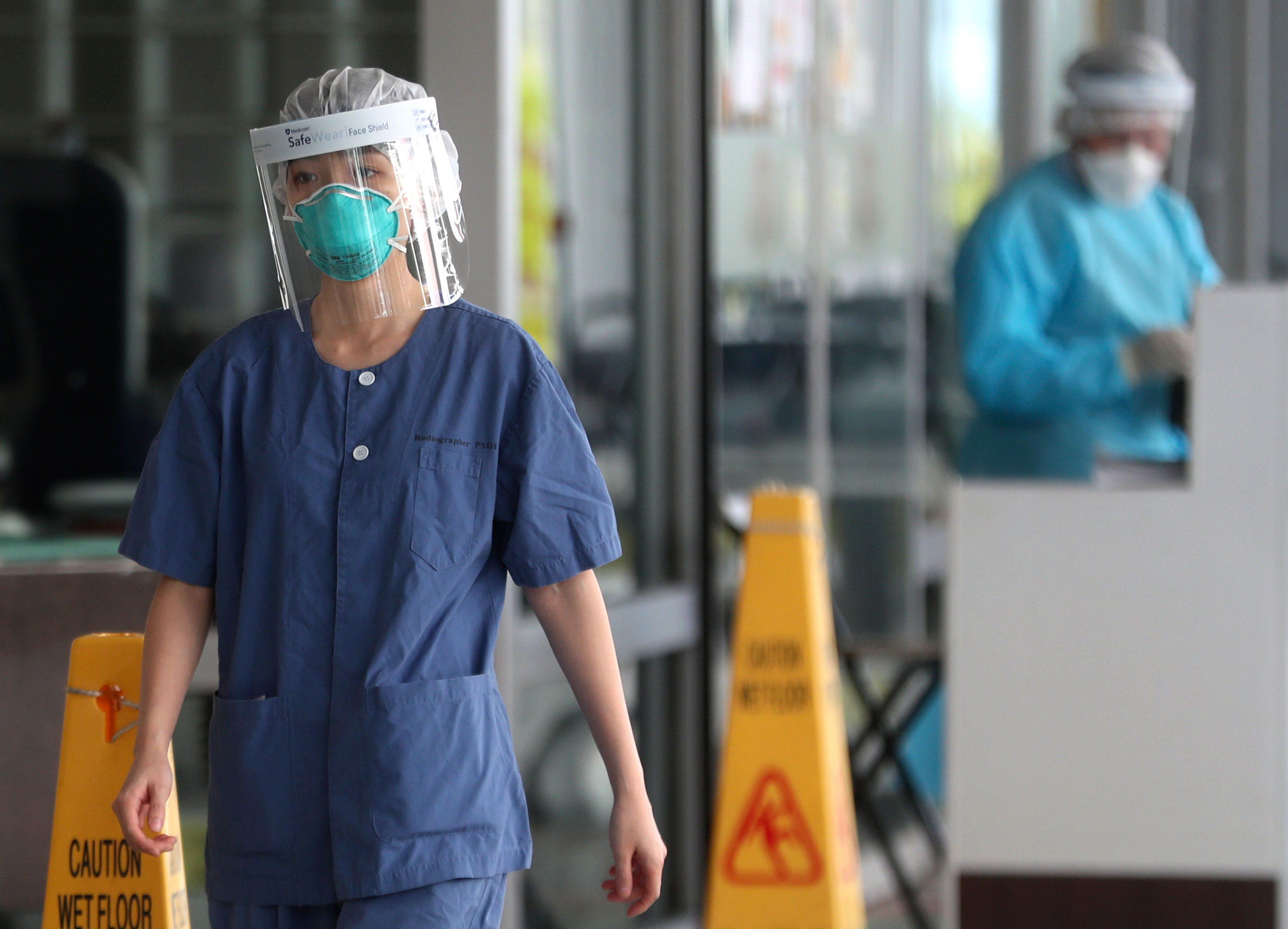 Hospital staff wear face protection at the Princess Margaret Hospital in Hong Kong, Saturday, February 1.