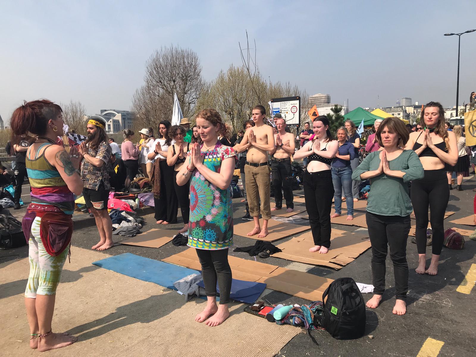 Demonstrators take part in a yoga session on Waterloo Bridge in London on Wednesday. 