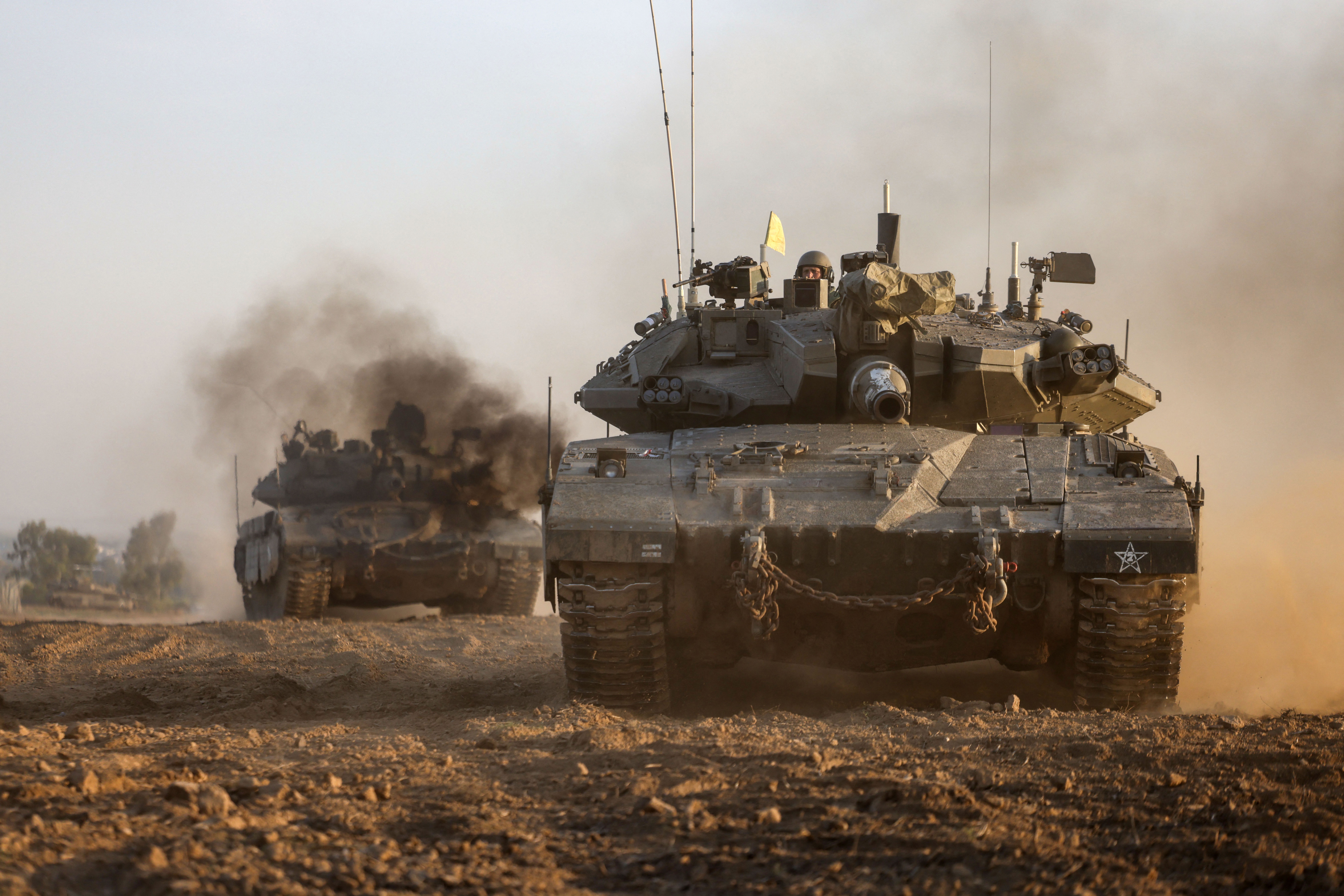 Israeli military tanks maneuver near the border with Gaza on Sunday, December 3.