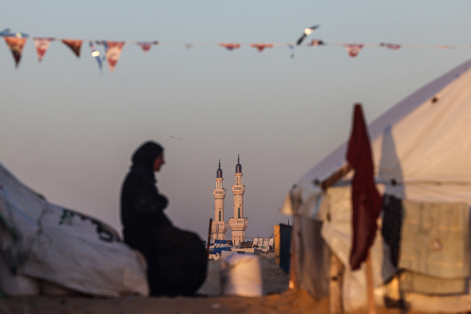 A Palestinian woman in Rafah sits at a camp for displaced people on the first day of Ramadan on March 11.