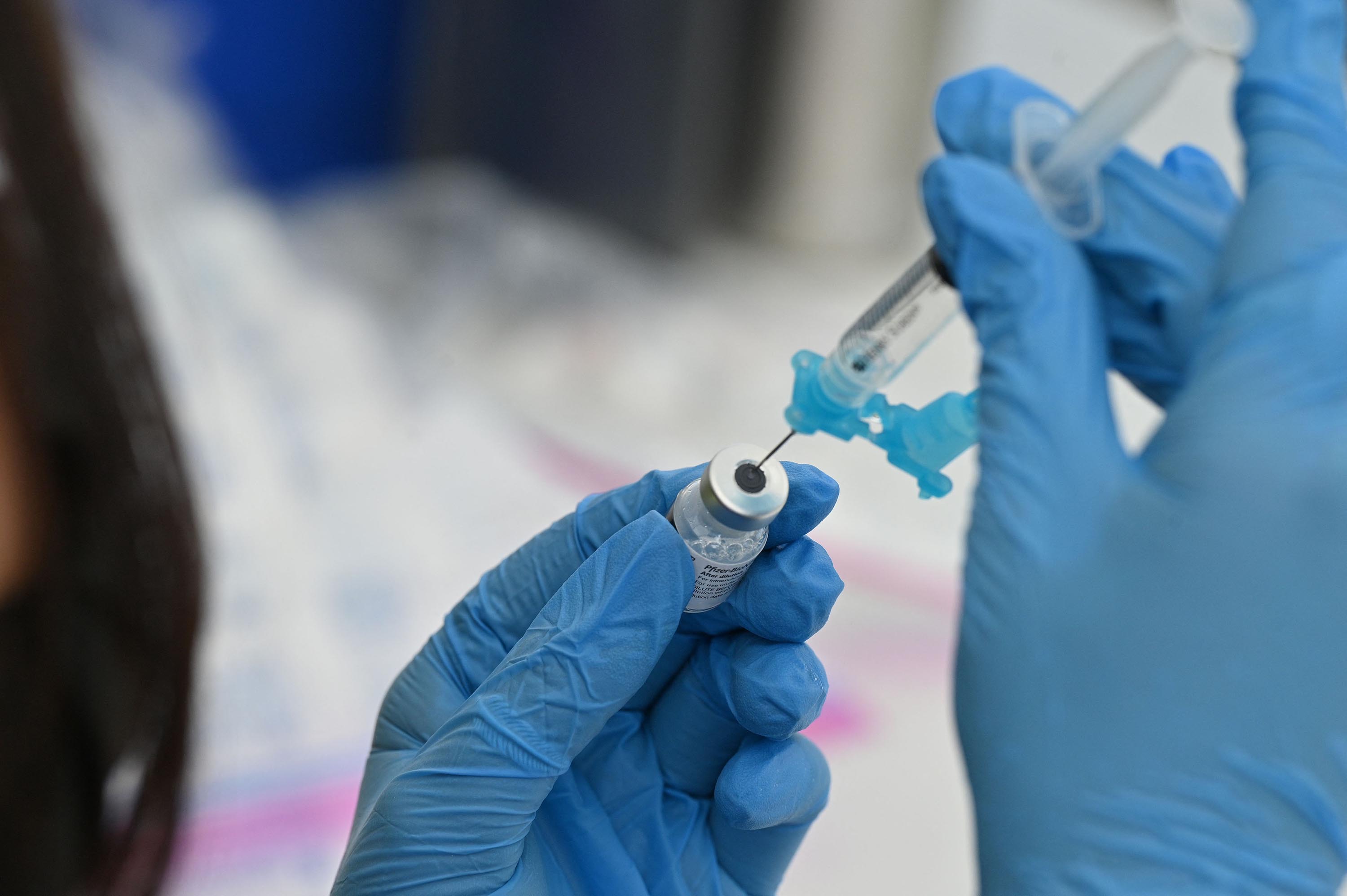 A healthcare worker fills a syringe with a Covid-19 vaccine at a community vaccination event in Los Angeles, California, on August 11. 